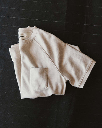 editorial flatlay of The Short Sleeve Sunset Crew in Heather Oat Terry folded