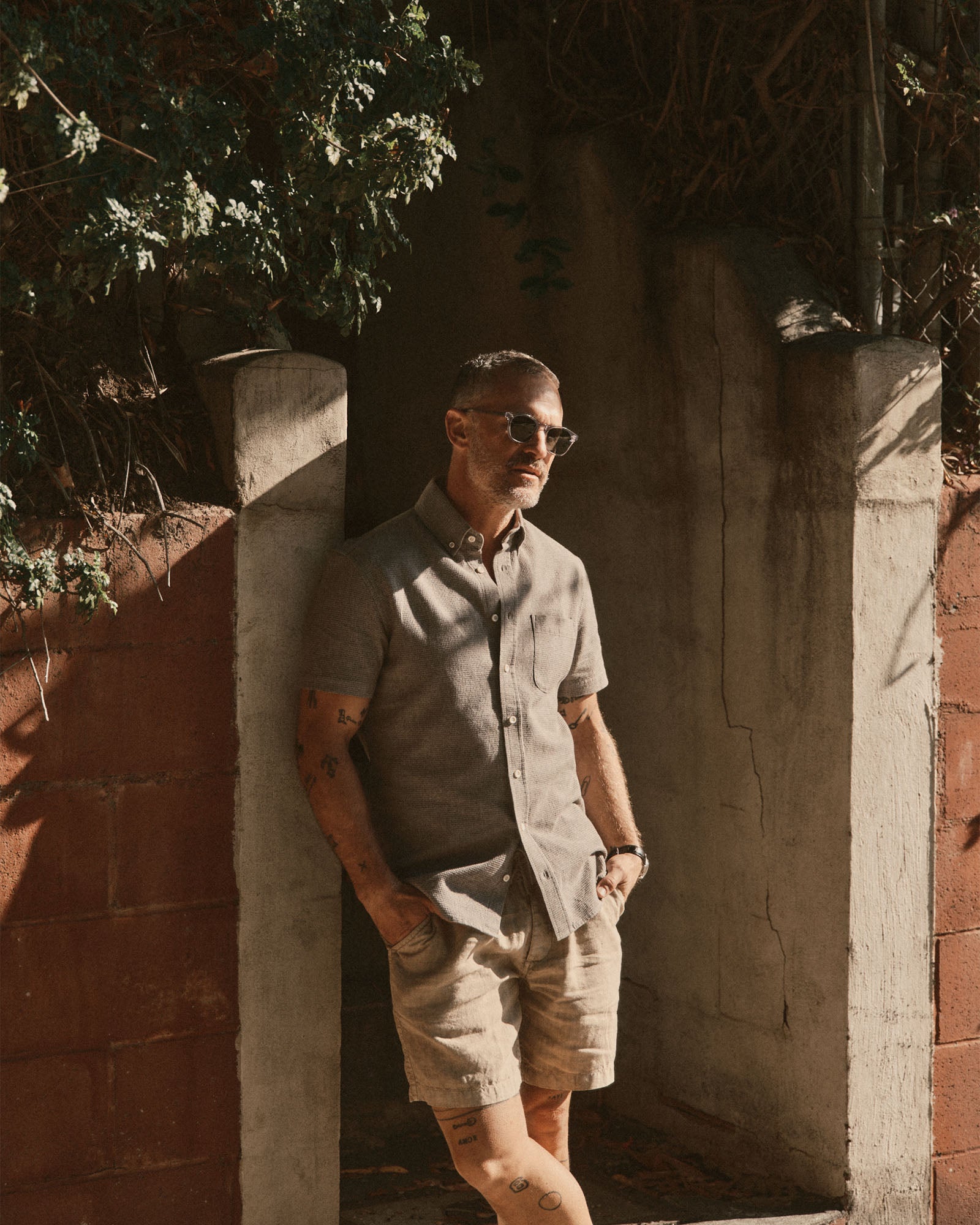 fit model leaning against the wall wearing The Short Sleeve Jack in Fern Twist Waffle, Wovens by Taylor Stitch