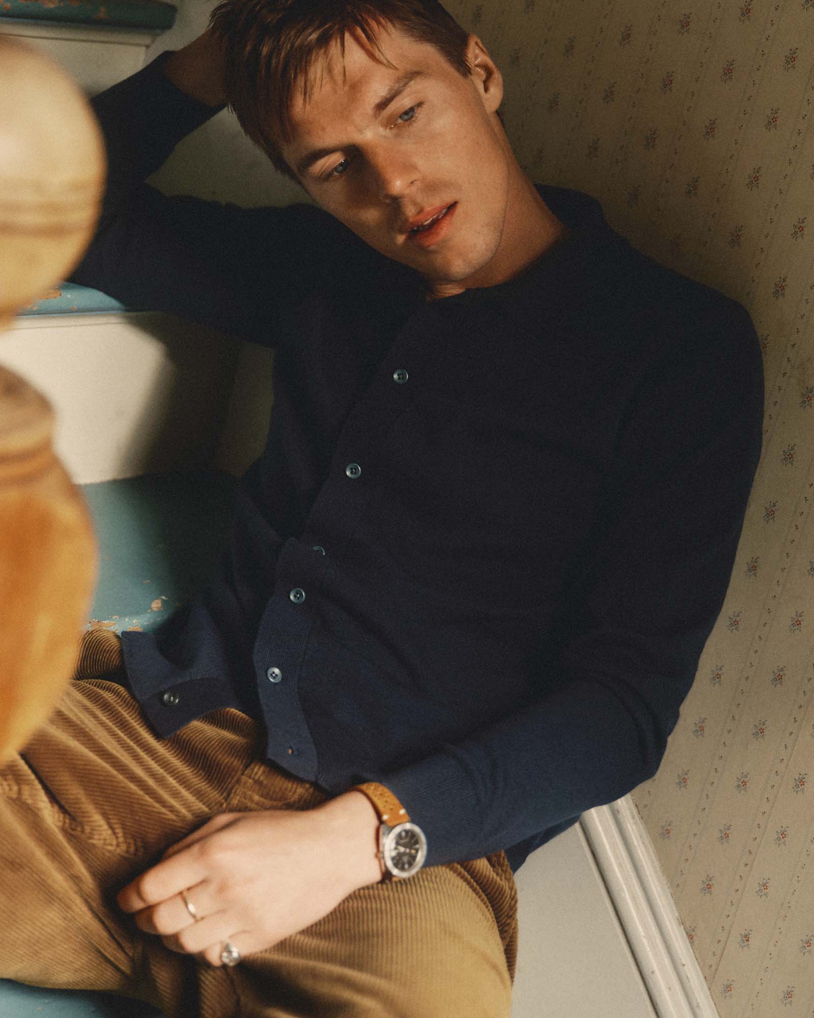 fit model sitting wearing The Nichols Polo in Nocturne Cotton Cashmere, Knits by Taylor Stitch