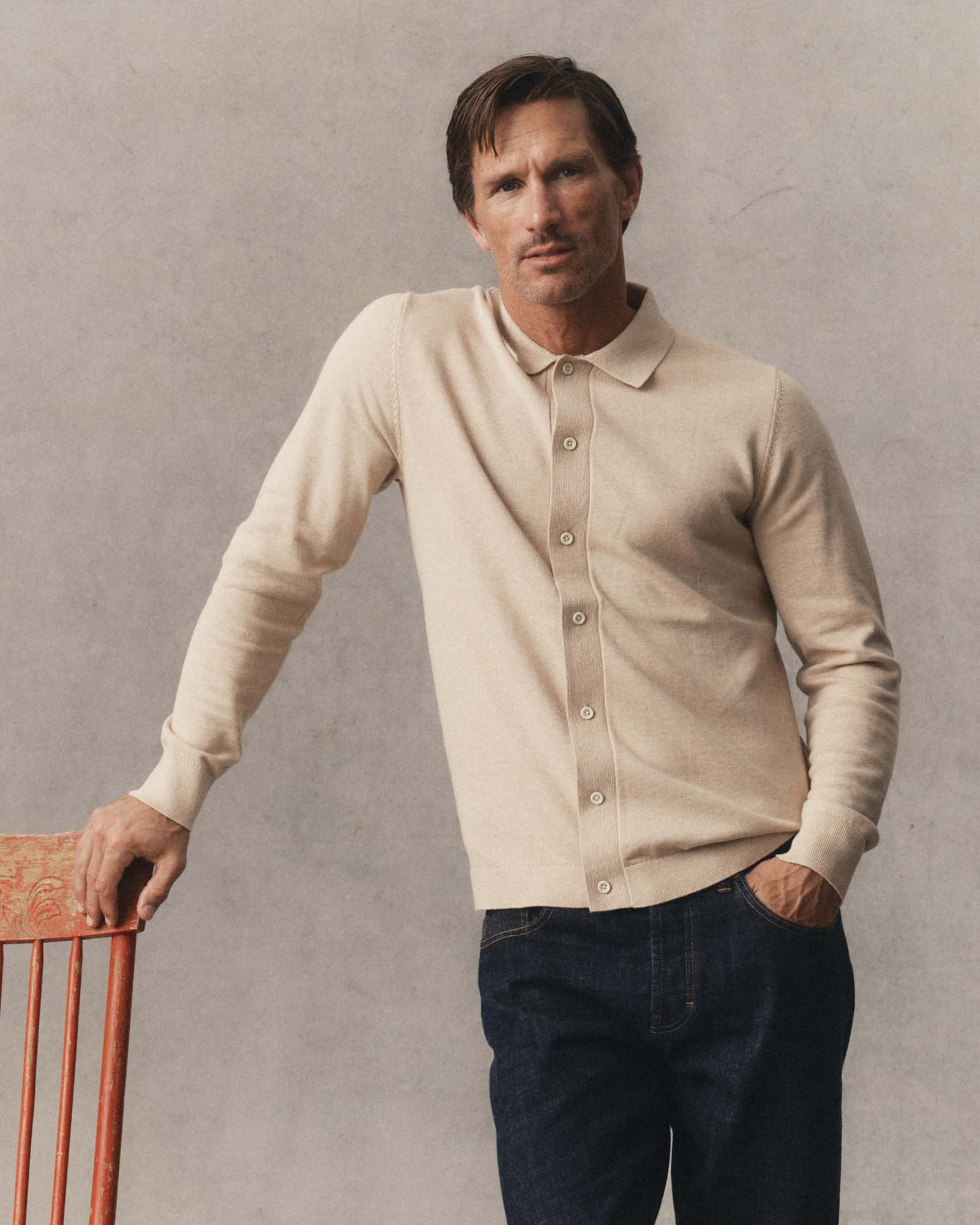 fit model posing in The Nichols Polo in Sable Cotton Cashmere, Knits by Taylor Stitch
