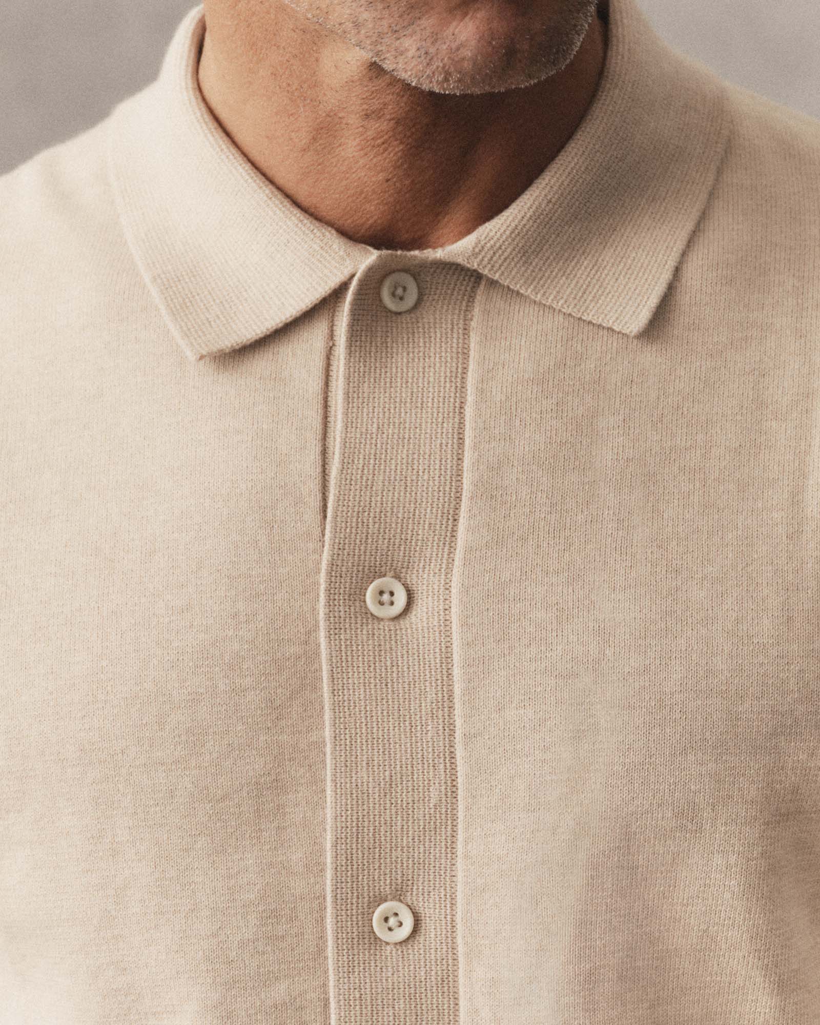 fit model showing off the buttons on The Nichols Polo in Sable Cotton Cashmere, Knits by Taylor Stitch