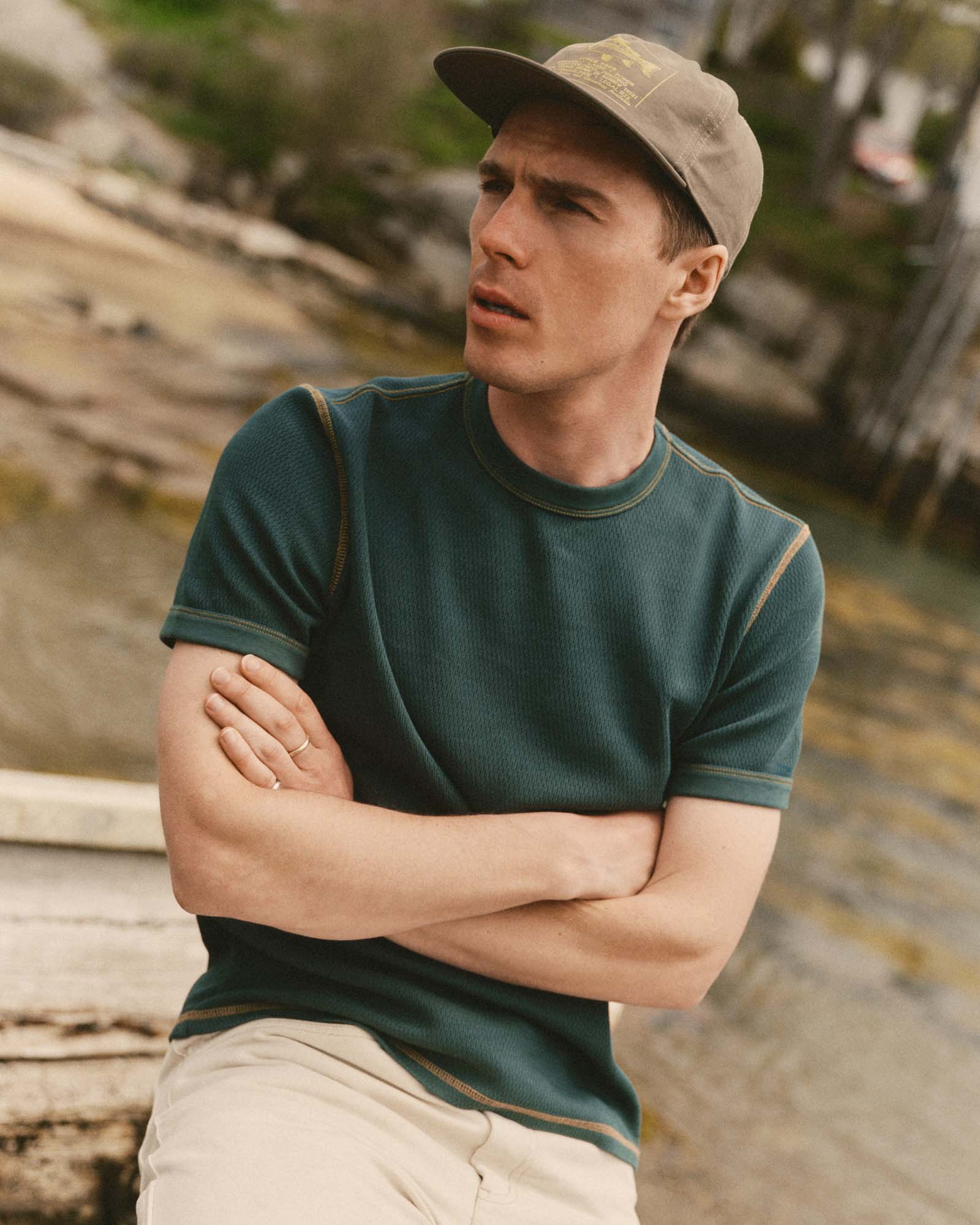 fit model sitting wearing The Organic Cotton Short Sleeve Crew in Dark Forest Waffle, Knits by Taylor Stitch