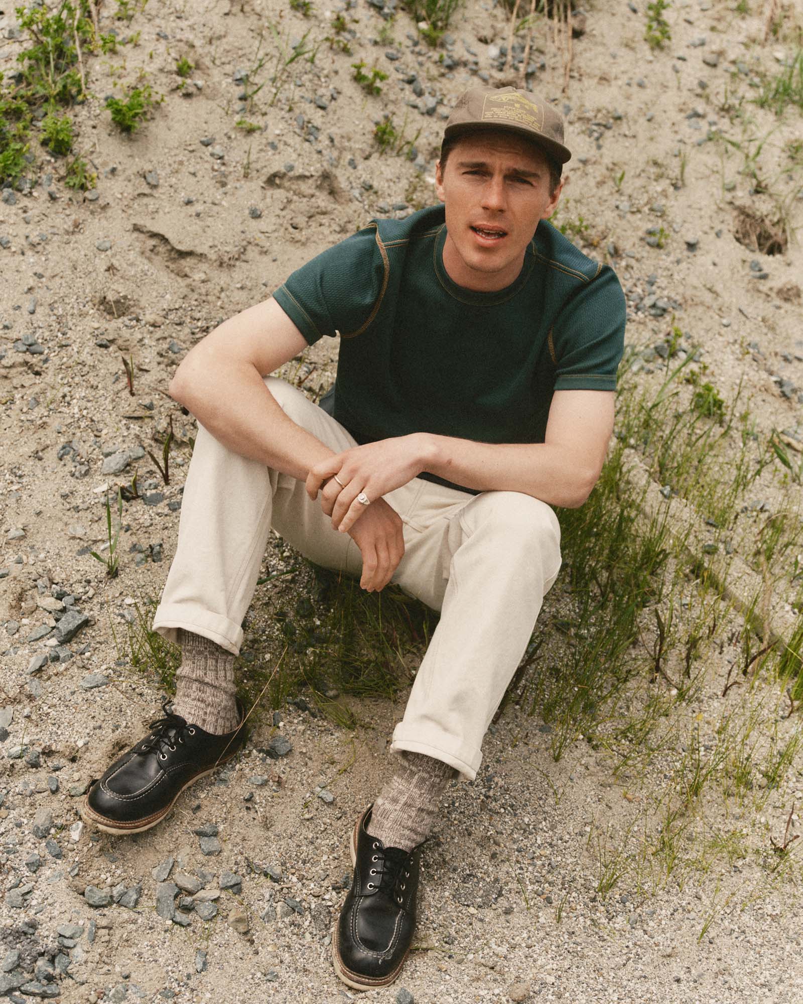 fit model sitting wearing The Organic Cotton Short Sleeve Crew in Dark Forest Waffle, Knits by Taylor Stitch