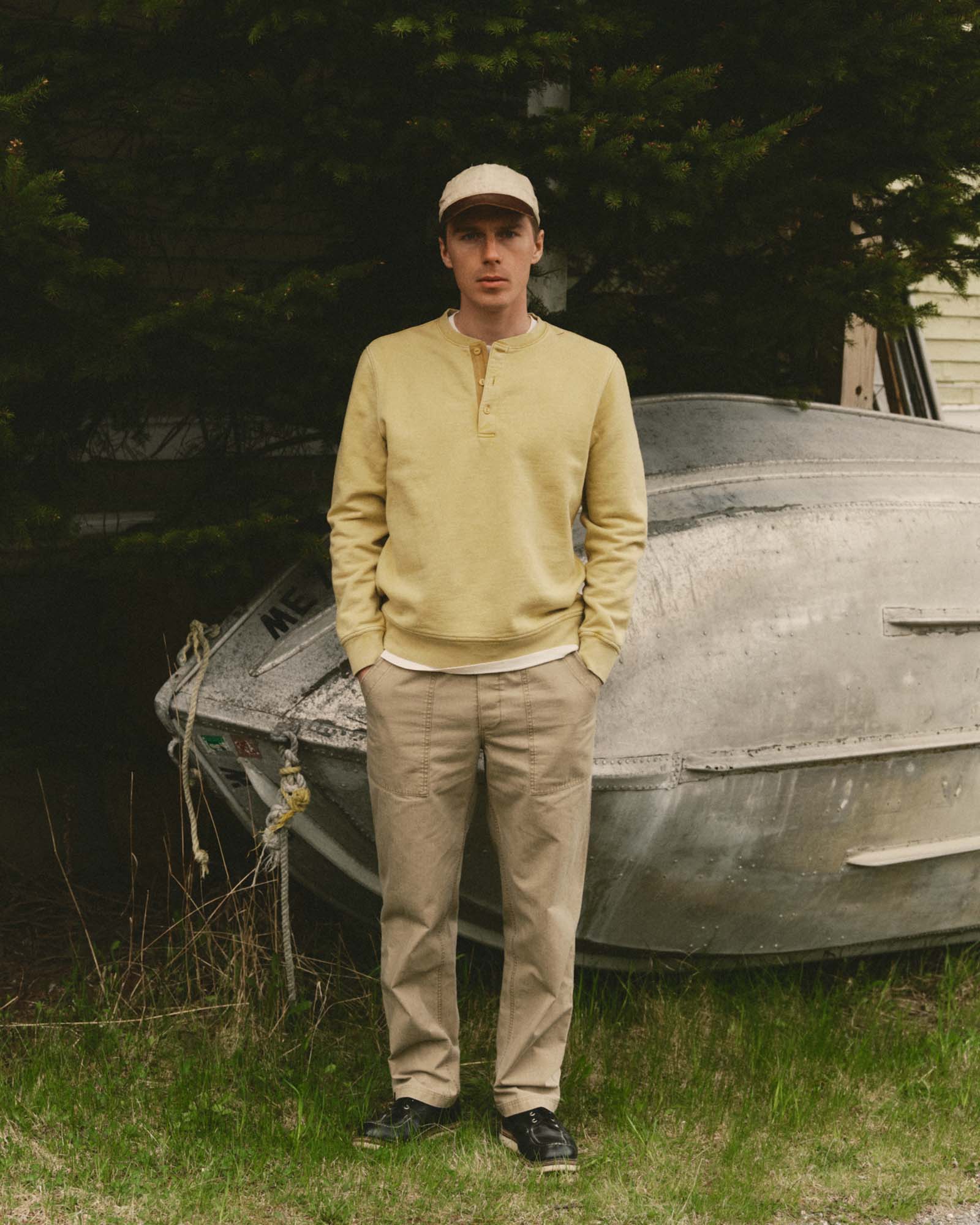 fit model posing in The Sunset Henley in Washed Goldfinch Terry, Knits by Taylor Stitch