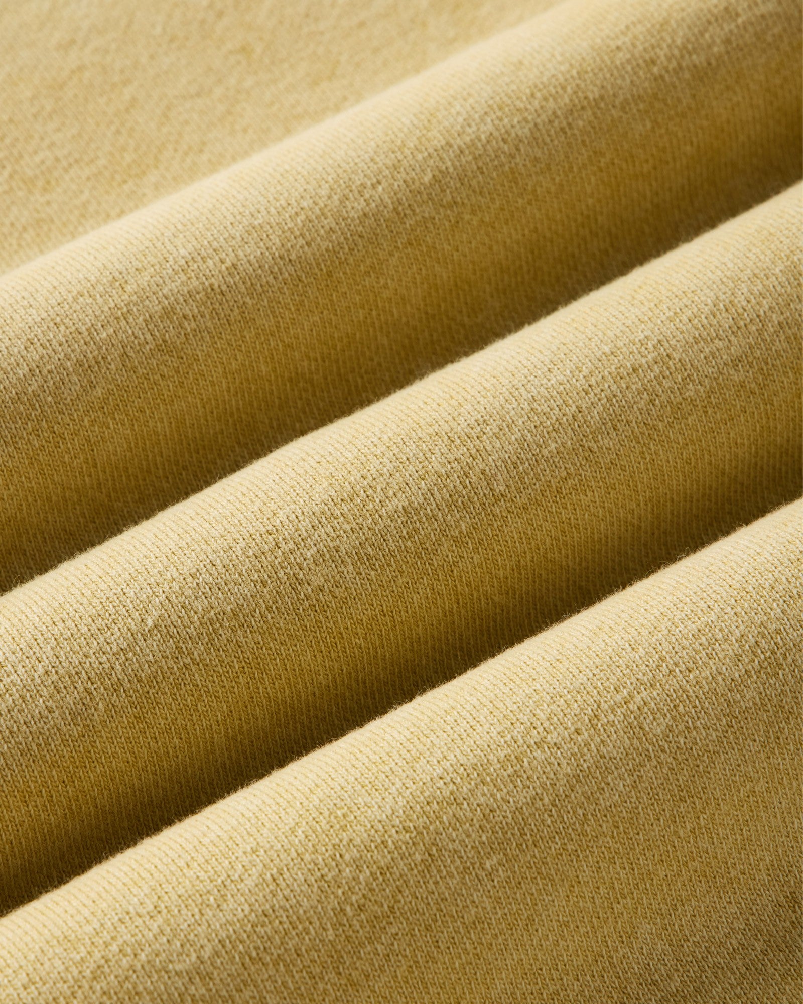 material shot of the fabric on The Sunset Henley in Washed Goldfinch Terry, Knits by Taylor Stitch