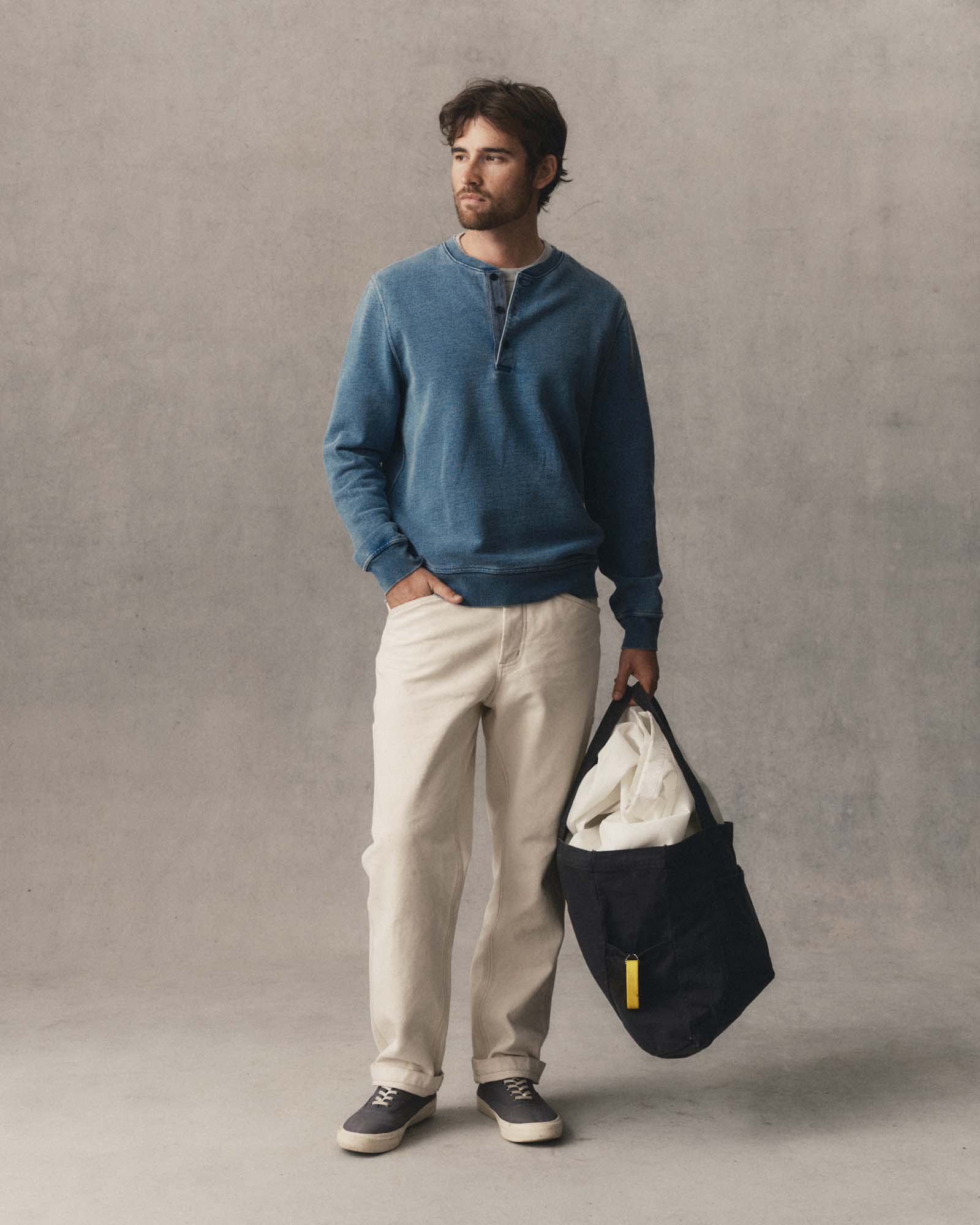 fit model posing in The Sunset Henley in Washed Indigo Terry, Knits by Taylor Stitch