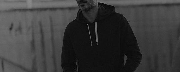 fit model posing in The Shop Hoodie in Faded Black