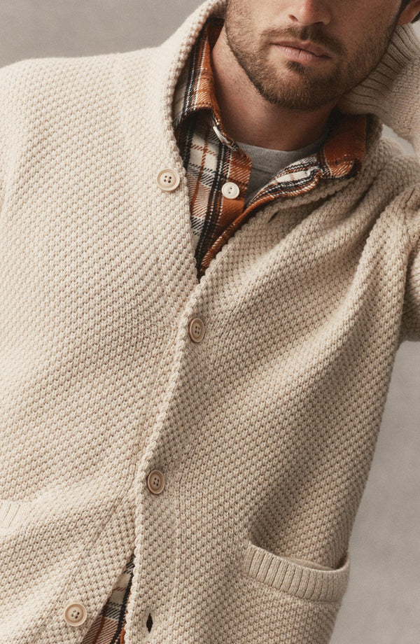 editorial image of The Crawford Sweater in Marled Natural hanging