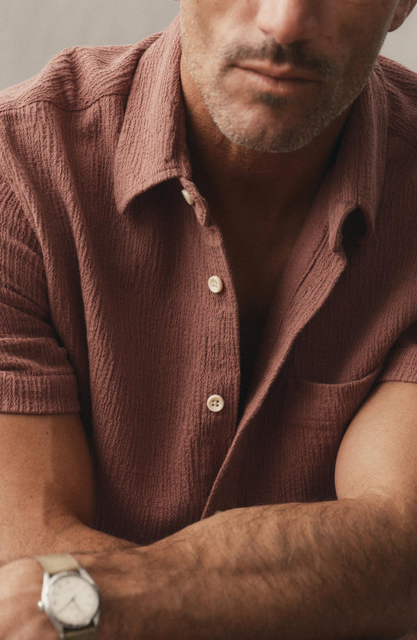 fit model sitting wearing The Short Sleeve California in Redwood Hacci