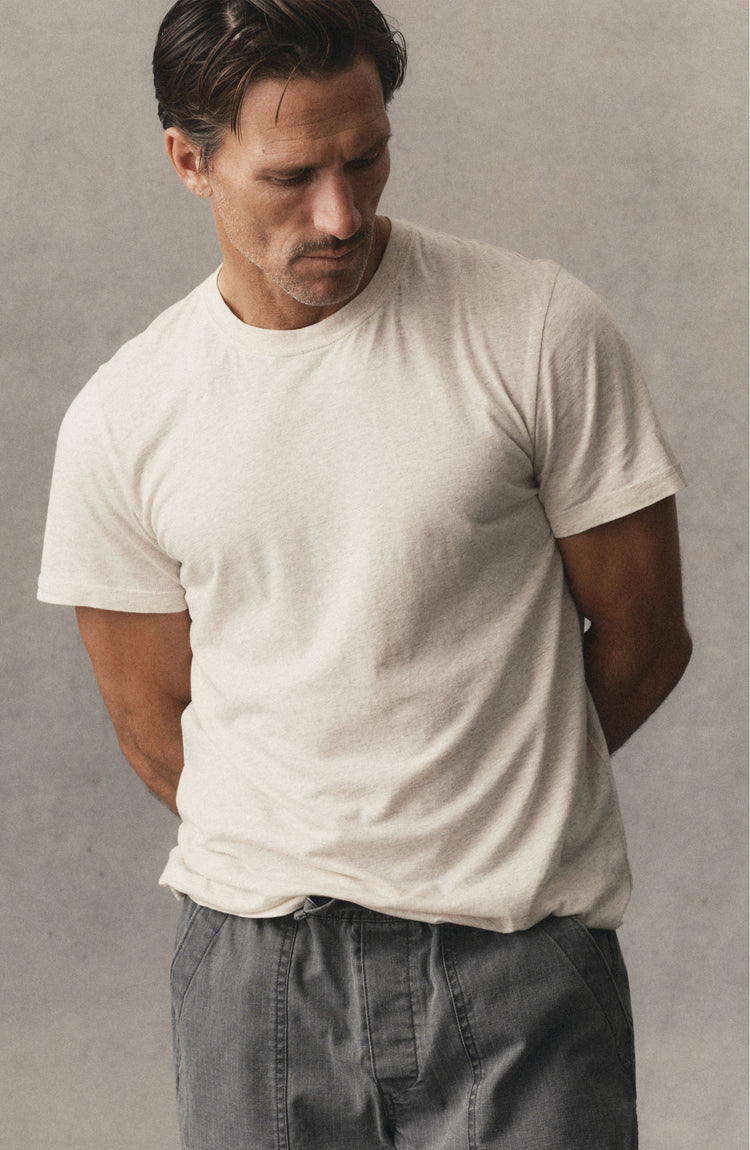 editorial image of The Cotton Hemp Tee in Heather Oat hanging in a window