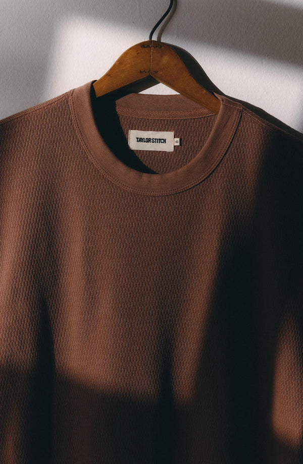 editorial image of The Organic Cotton Short Sleeve Crew in Faded Brick Waffle hanging