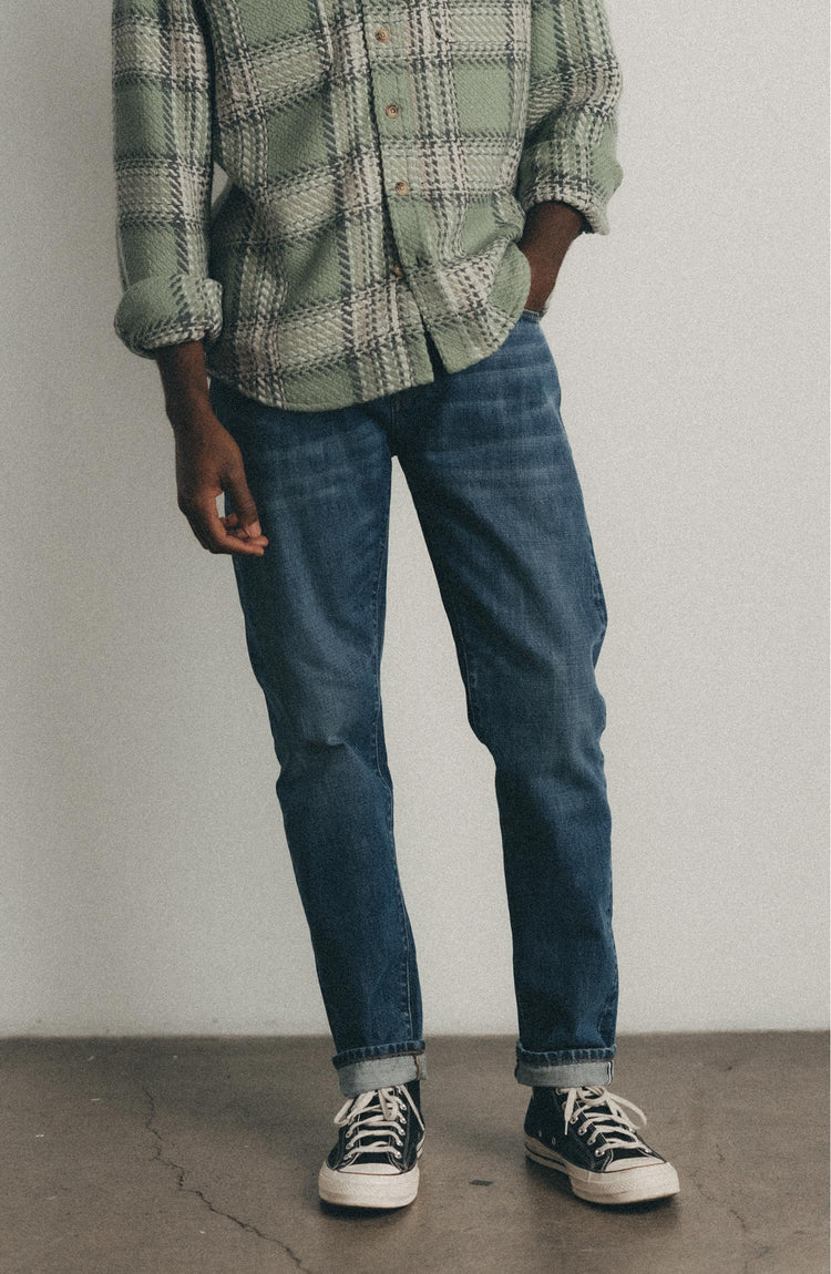 editorial image of The Slim Jean in Mid Wash Organic Selvedge hanging