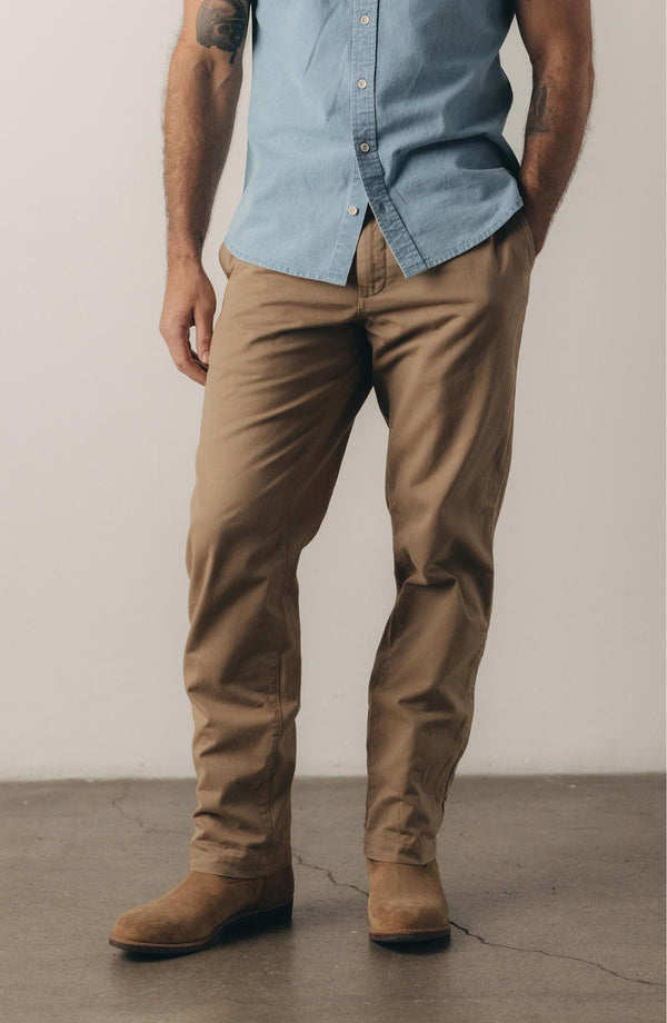 A pair of Foundation Pants folded on a black background.