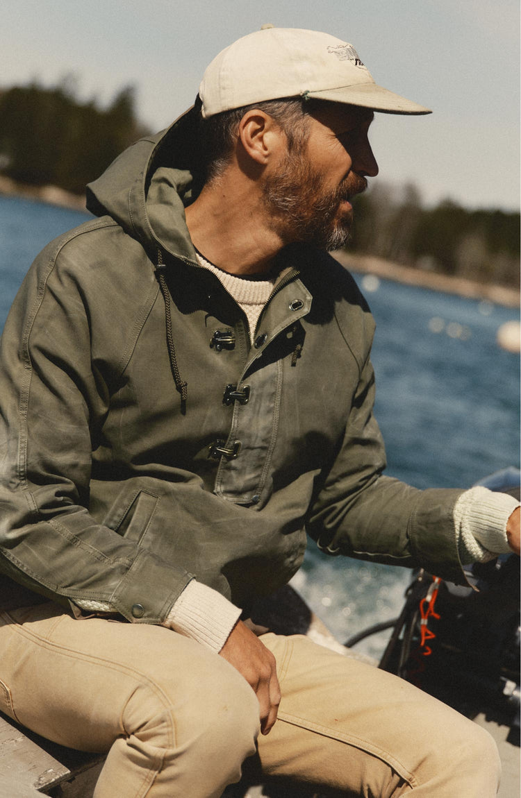fit model posing in The Hatteras Anorak in Fatigue Olive Dry Wax Canvas