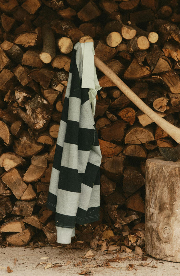 editorial image of The Rugby Shirt in Dark Forest Stripe on an ax