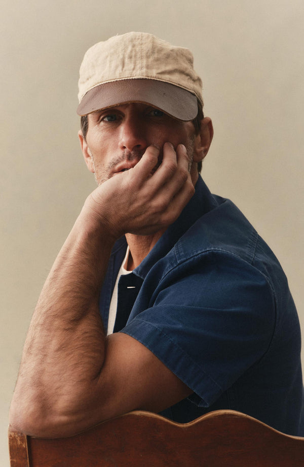 fit model sitting wearing The Short Sleeve Mechanic Shirt in Atlantic Ripstop