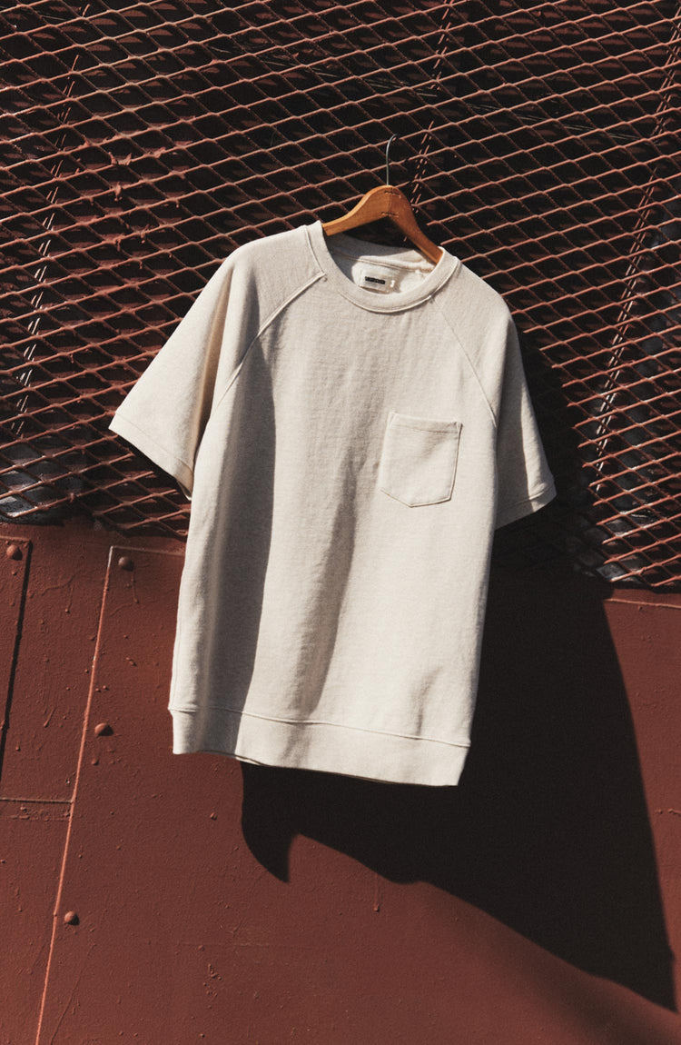 editorial image of The Short Sleeve Sunset Crew in Heather Oat Terry hanging