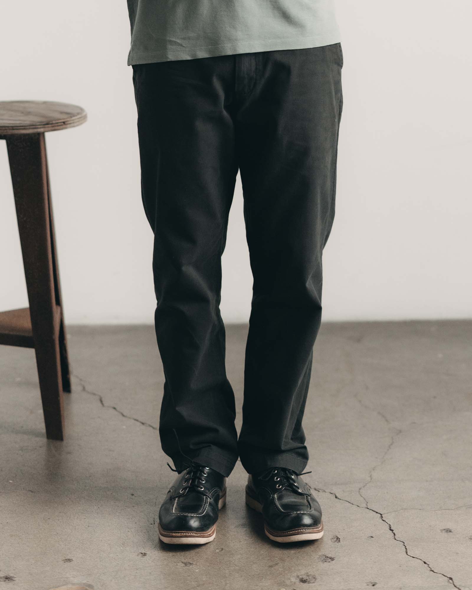 fit model with his hand in his pocket wearing The Democratic Foundation Pant in Organic Faded Black, Bottoms by Taylor Stitch