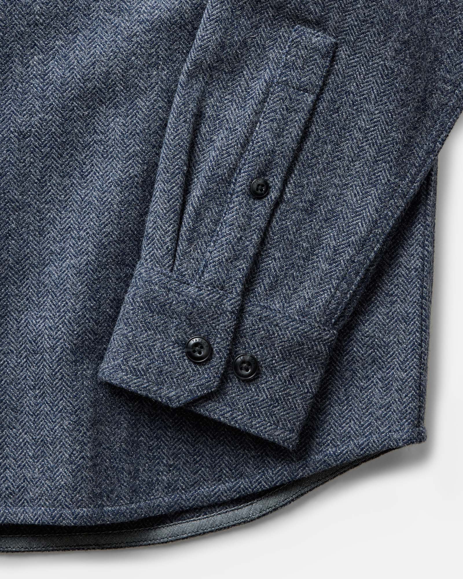 material shot of the sleeve on The CPO Overshirt in Indigo Ash Wool Herringbone, Wovens by Taylor Stitch