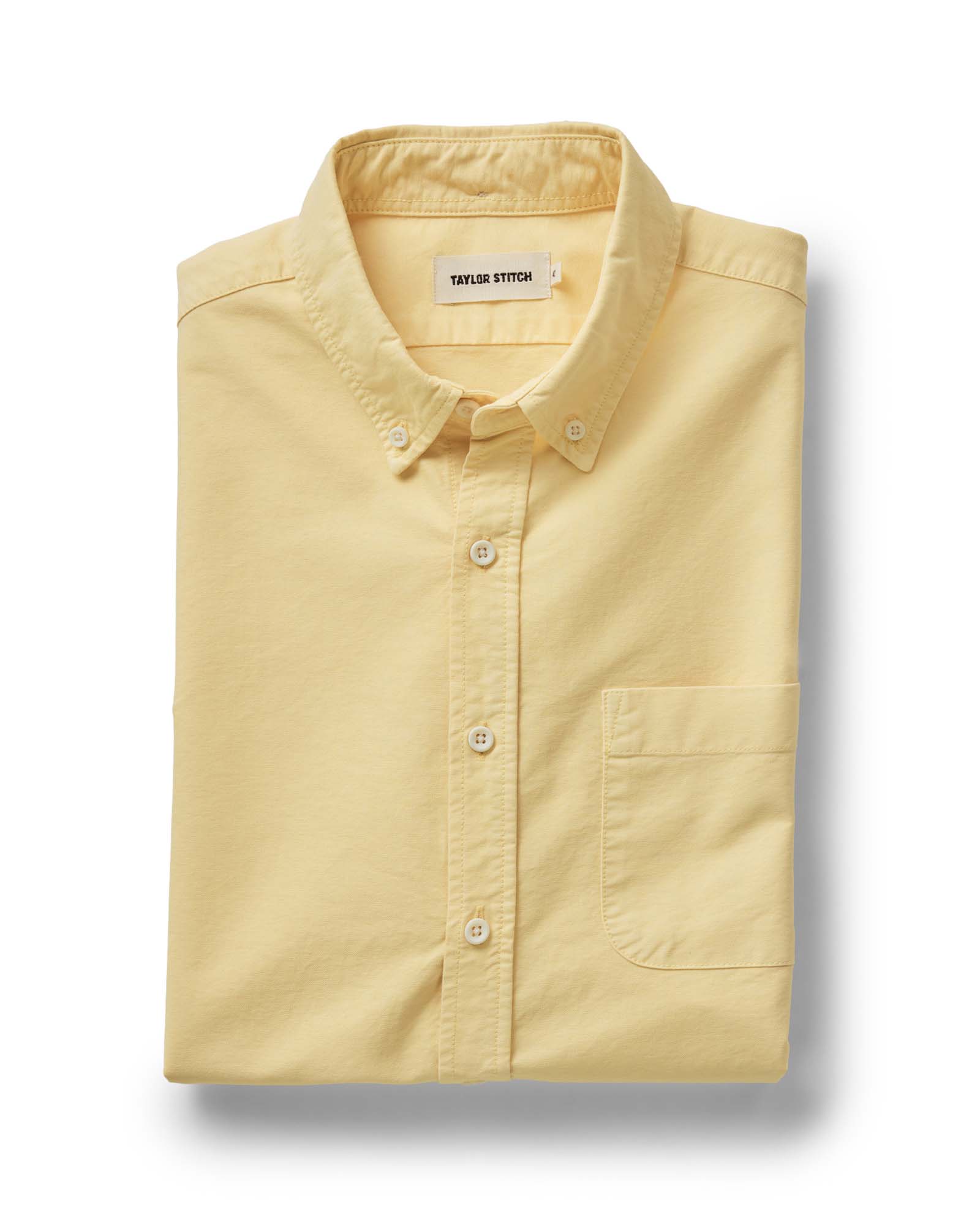 folded flatlay of The Jack in Straw Oxford, Wovens by Taylor Stitch