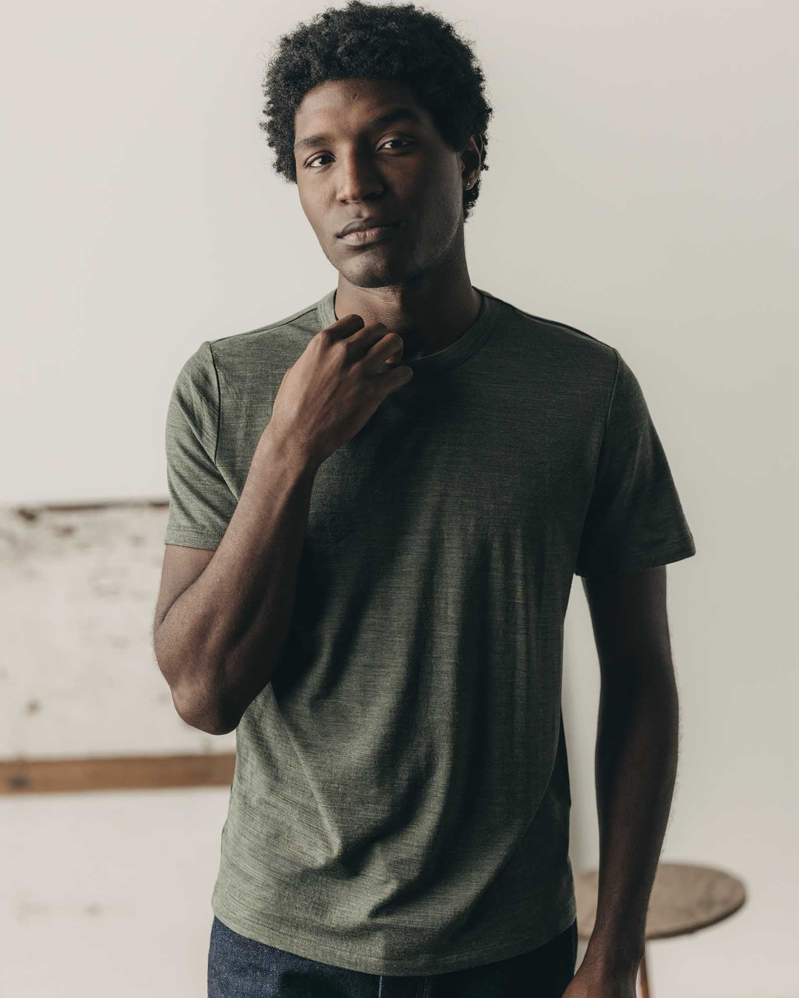 fit model leaning against the wall wearing The Merino Tee in Heather Army, Knits by Taylor Stitch
