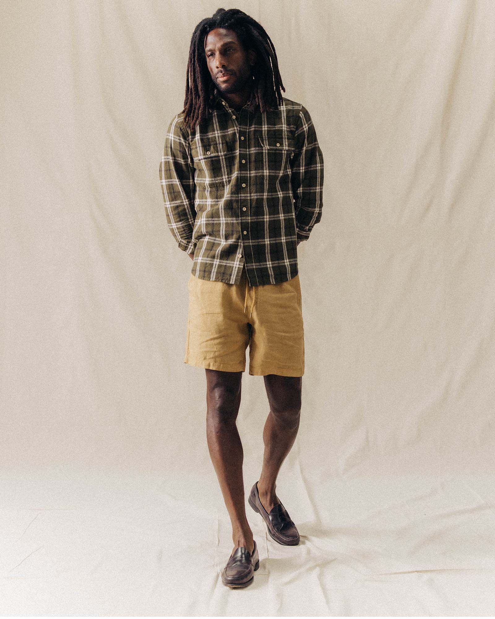 Model standing in The Apres Short in Wheat Hemp, Bottoms by Taylor Stitch