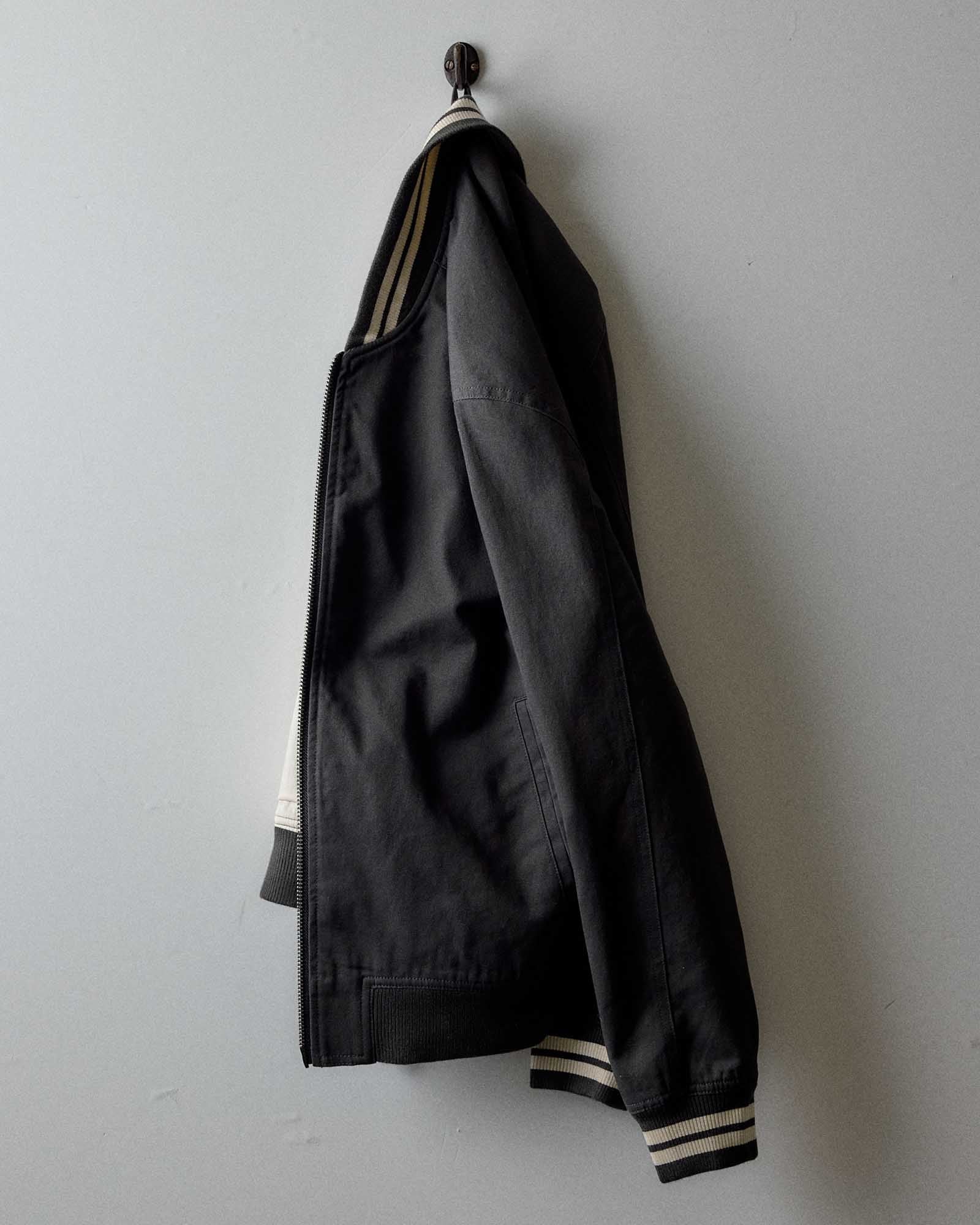 editorial image of The Speedway Bomber in Organic Faded Black Twill hanging, Outerwear by Taylor Stitch