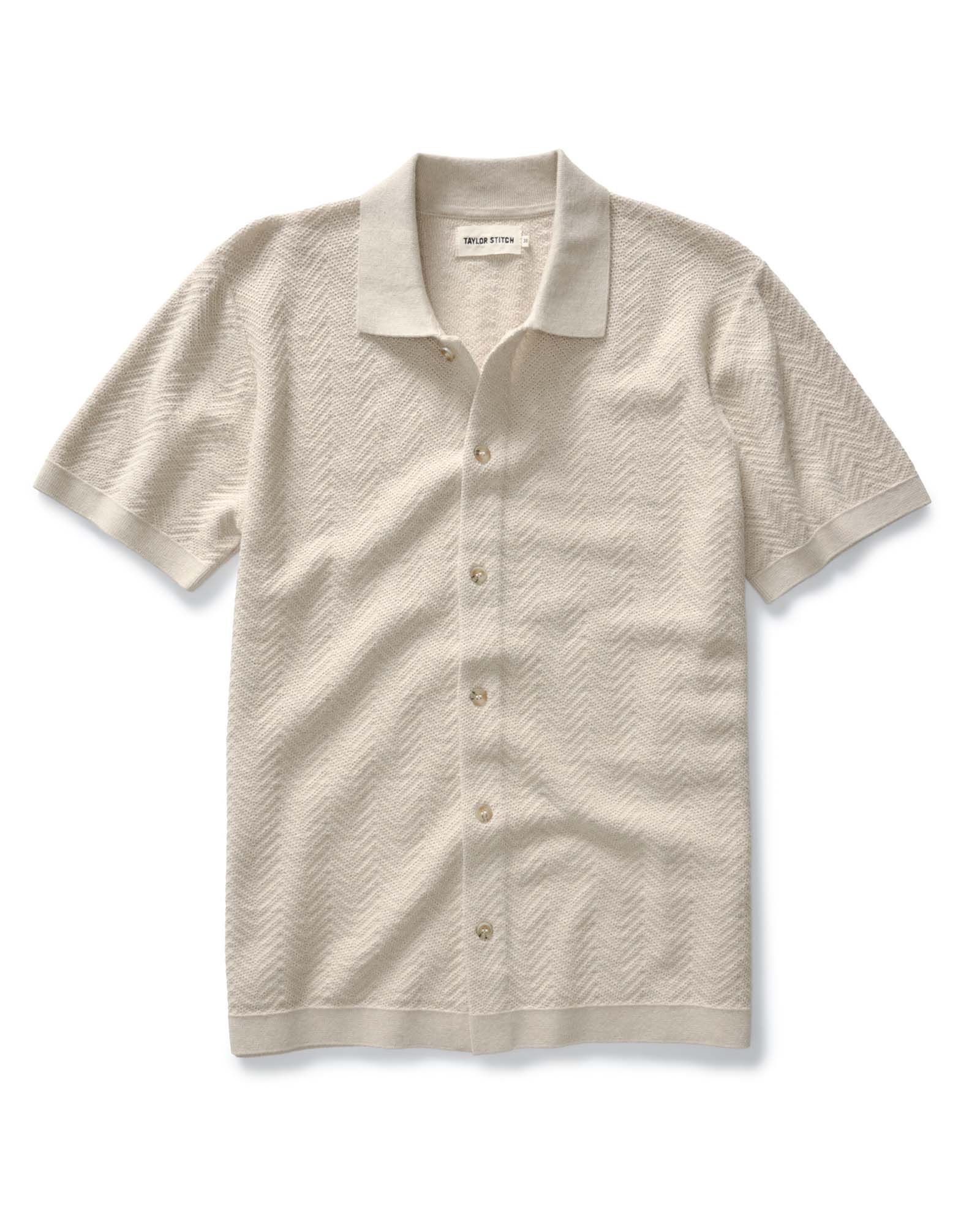 flatlay of The Button Down Polo in Heather Oat Herringbone, Knits by Taylor Stitch