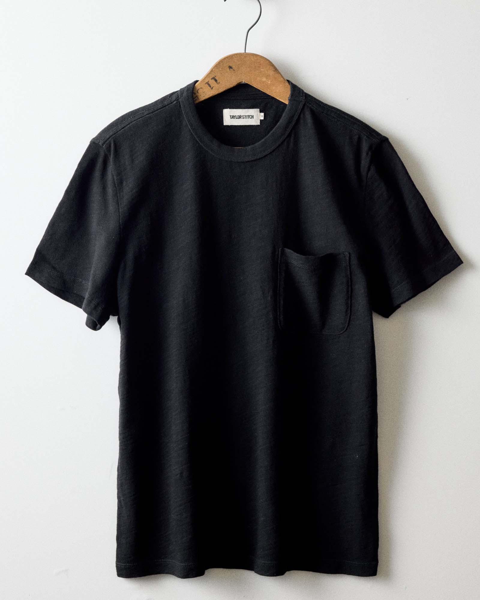 editorial image of The Organic Cotton Tee in Black Indigo hanging, Knits by Taylor Stitch