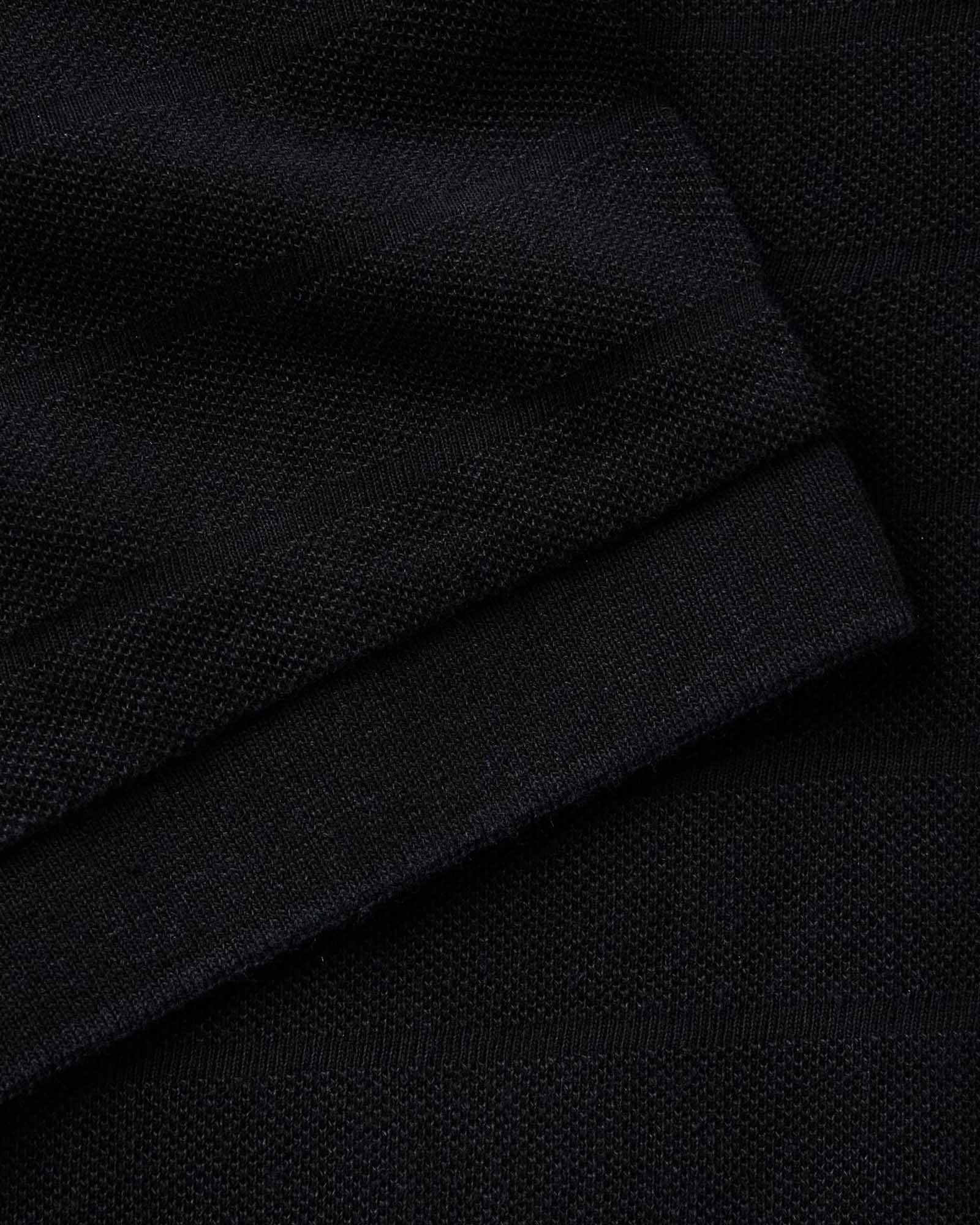 material shot of the sleeve on The Pacific Polo in Black Indigo Pique Stripe, Knits by Taylor Stitch