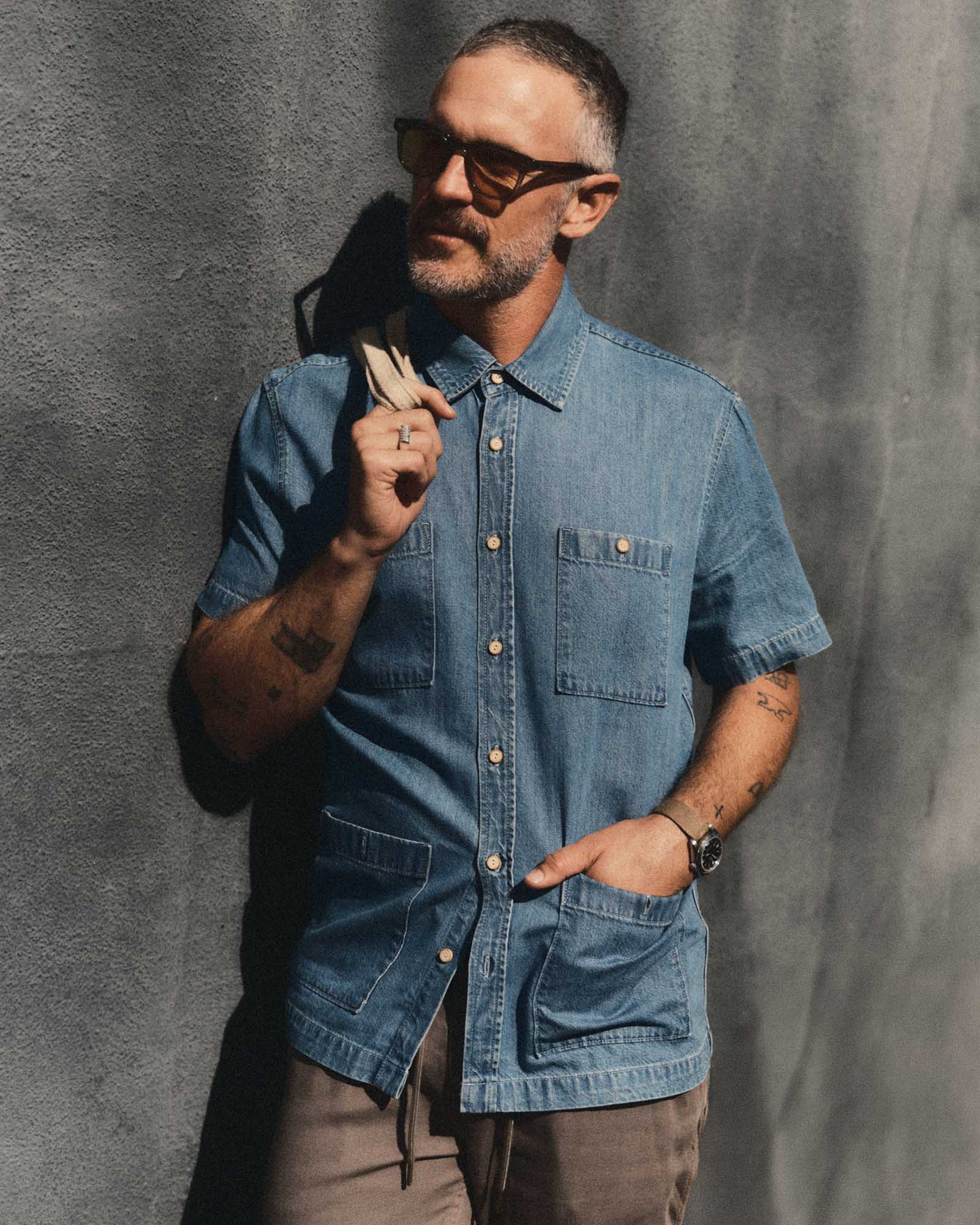 fit model posing in The Gulf Shirt in Washed Indigo Twill, Wovens by Taylor Stitch
