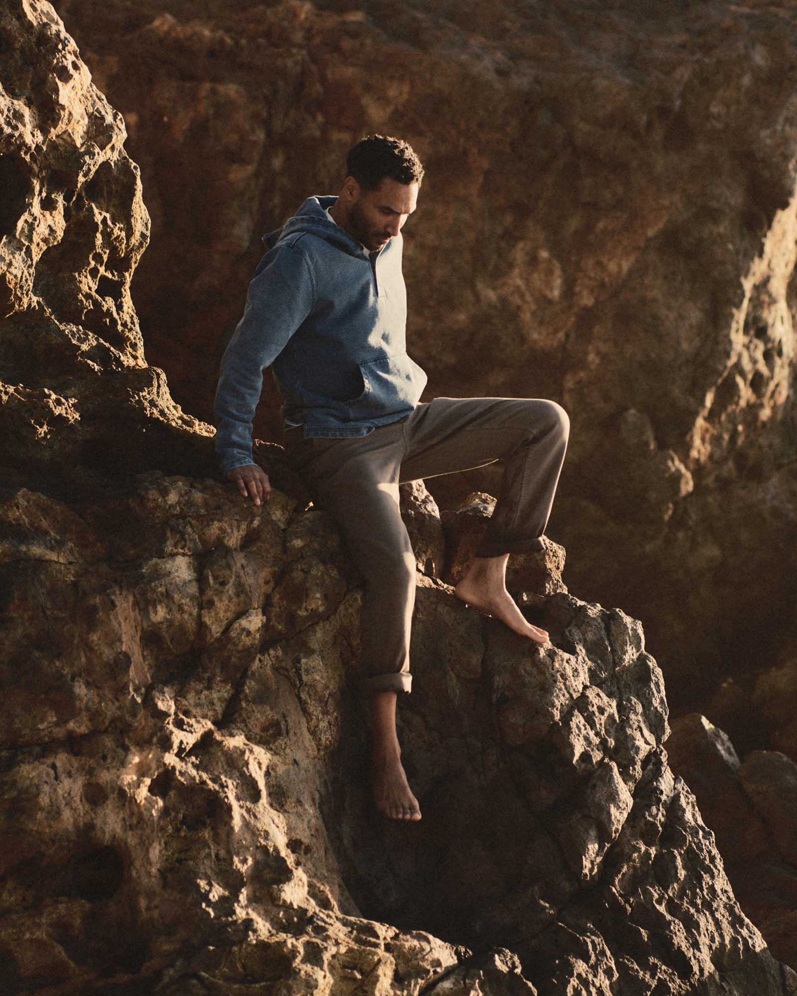 fit model sitting wearing The Roamer Pant in Smoked Olive Broken Twill, Bottoms by Taylor Stitch