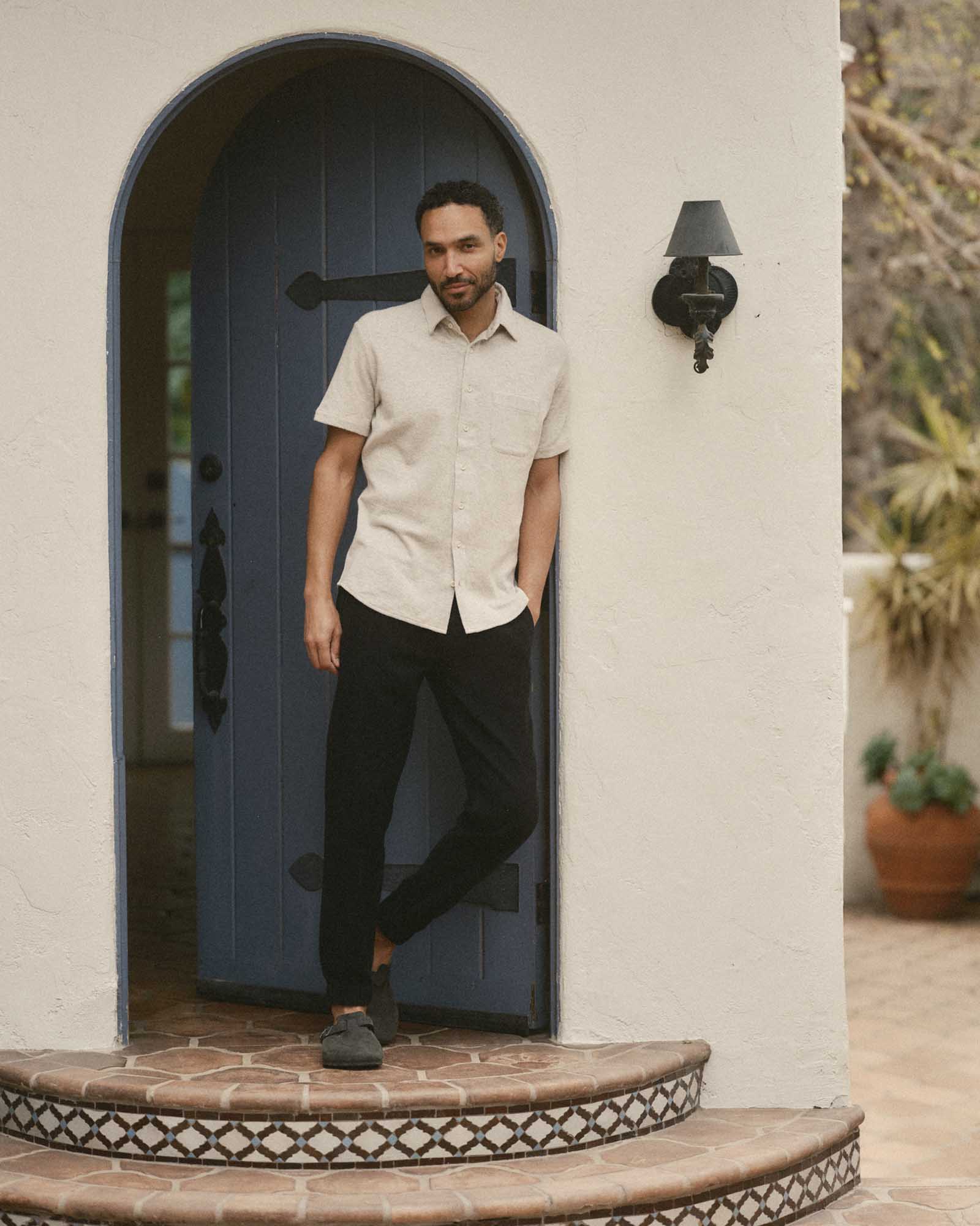 fit model posing in The Short Sleeve California in Heather Oat Double Knit, Knits by Taylor Stitch