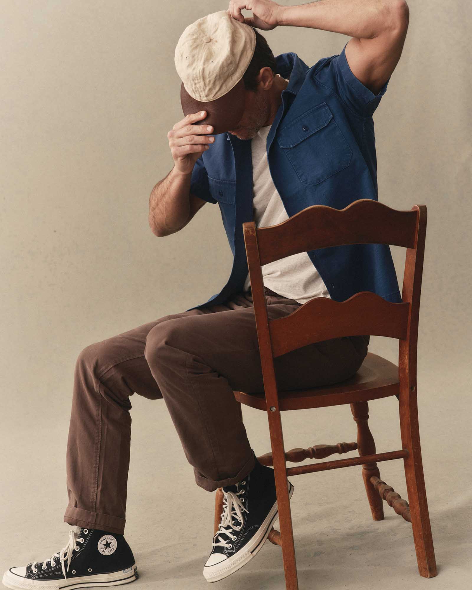 fit model sitting wearing The Short Sleeve Mechanic Shirt in Atlantic Ripstop, Wovens by Taylor Stitch