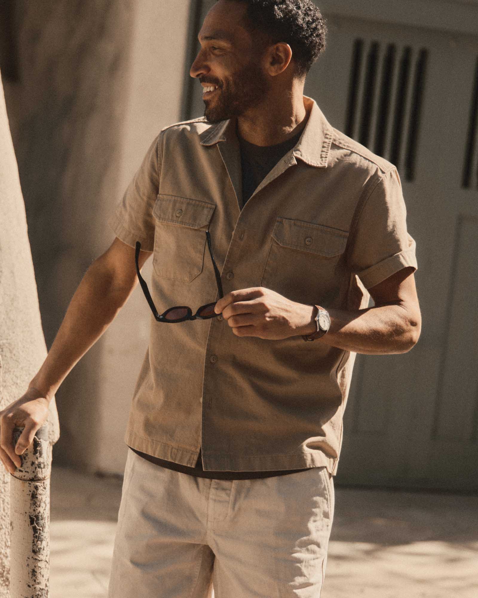 fit model posing in The Short Sleeve Mechanic Shirt in Khaki Ripstop, Wovens by Taylor Stitch