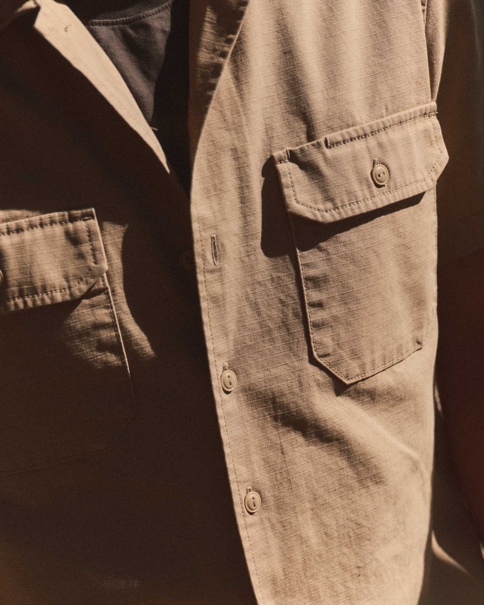 fit model showing off the pockets on The Short Sleeve Mechanic Shirt in Khaki Ripstop, Wovens by Taylor Stitch