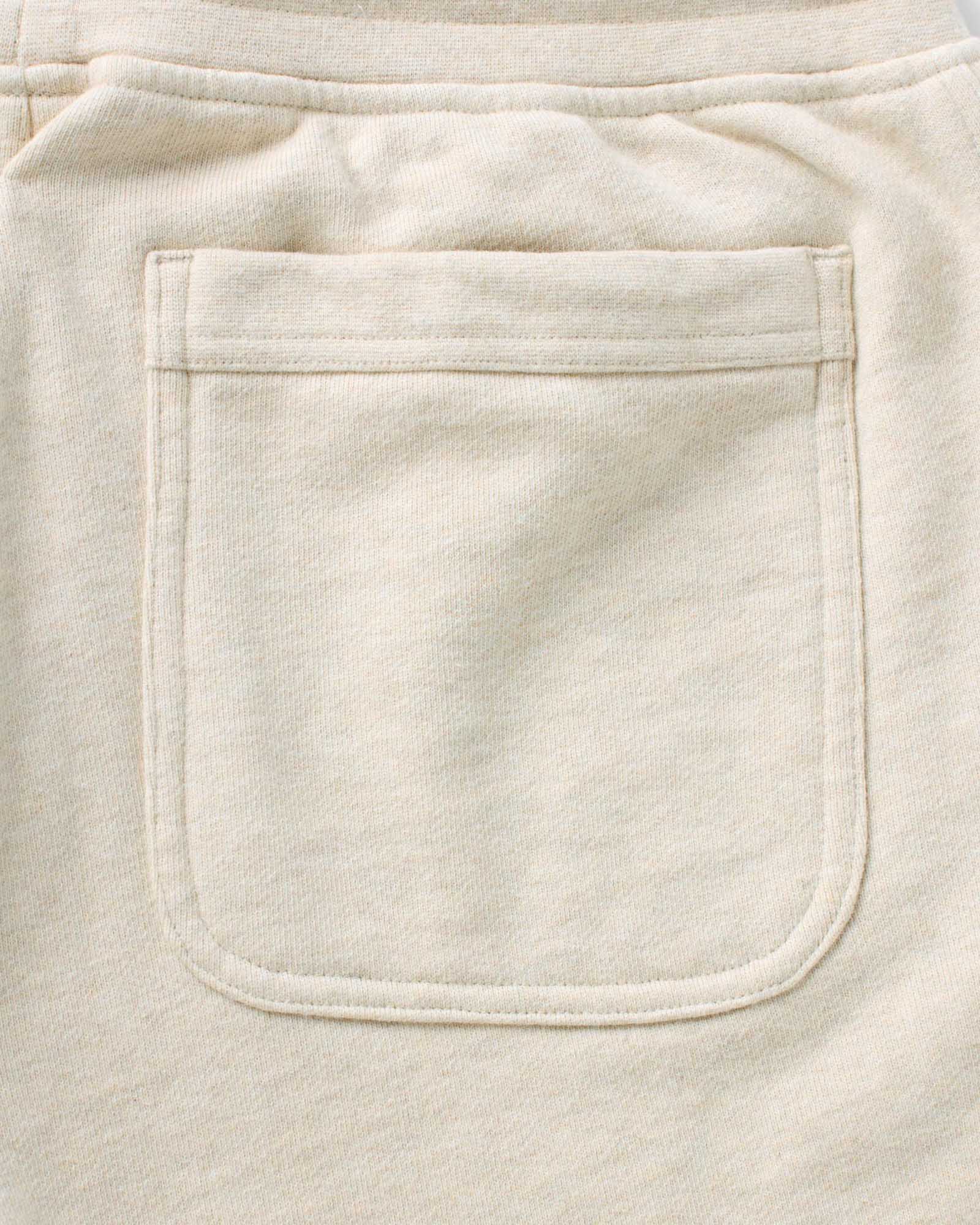 material shot of the back pocket on The Sunset Short in Heather Oat Terry, Bottoms by Taylor Stitch