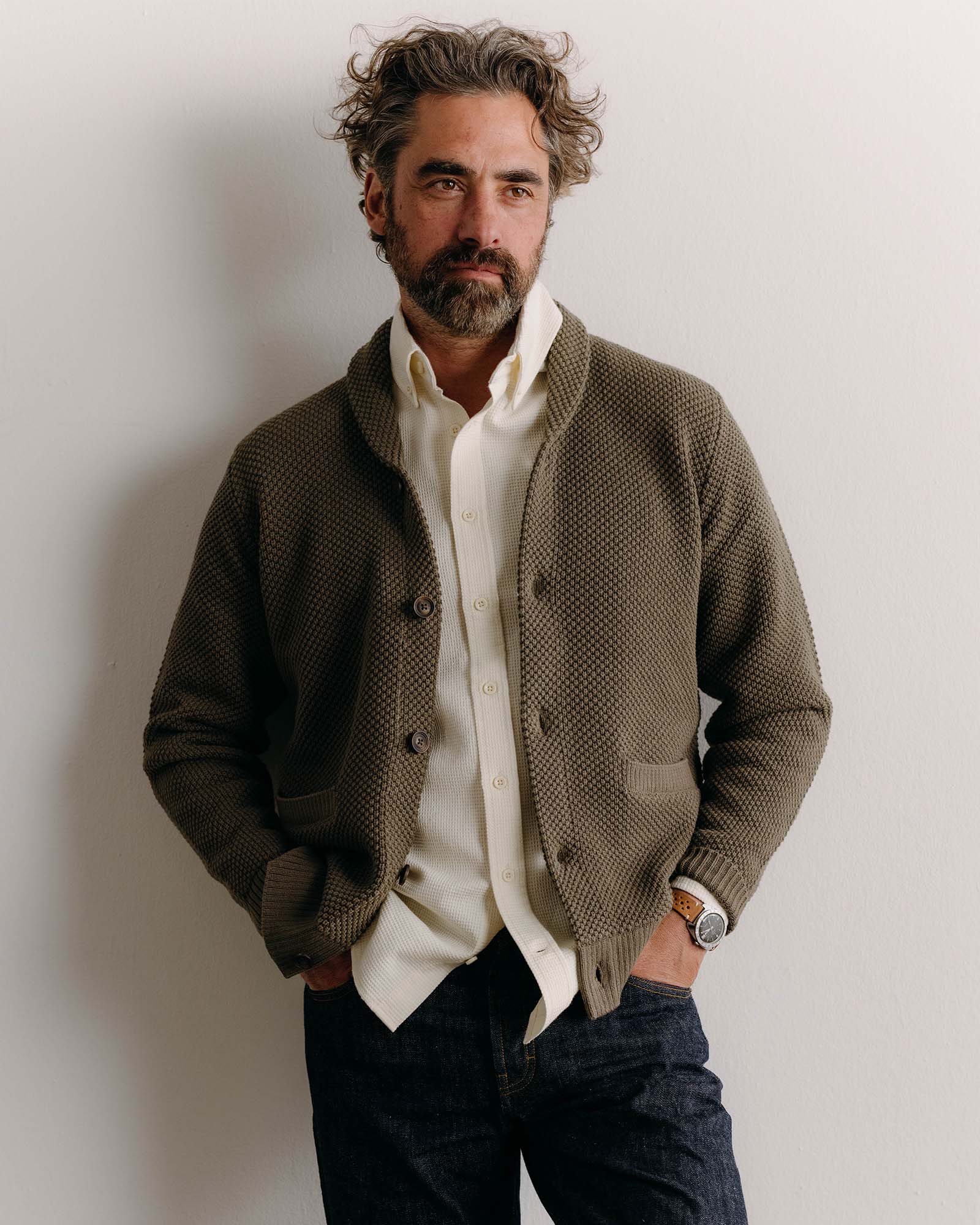 fit model posing wearing The Crawford Cardigan Sweater in Fatigue Olive, Knits by Taylor Stitch