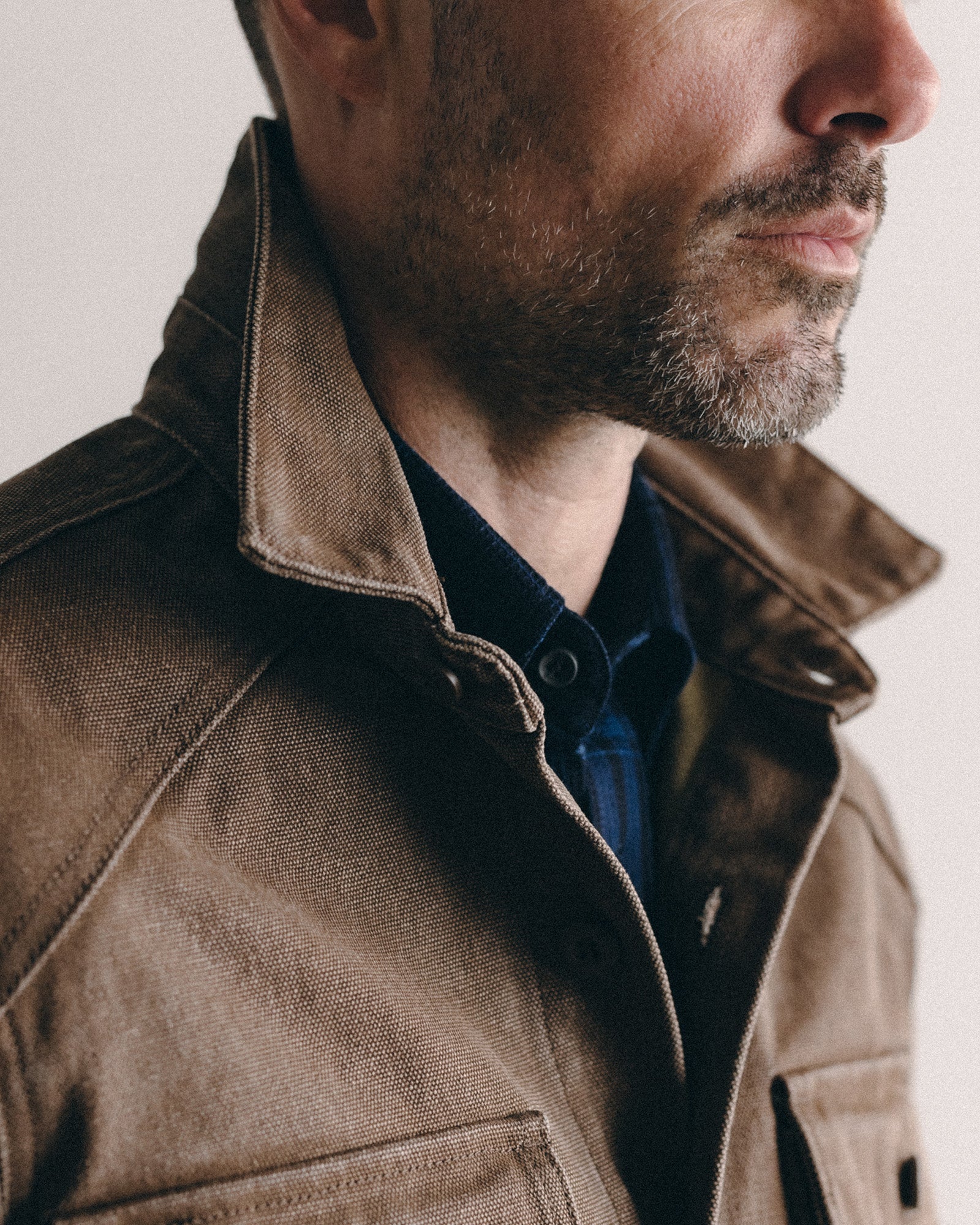 fit model showing off the collar on The Shop Shirt in Aged Penny Chipped Canvas, Wovens by Taylor Stitch
