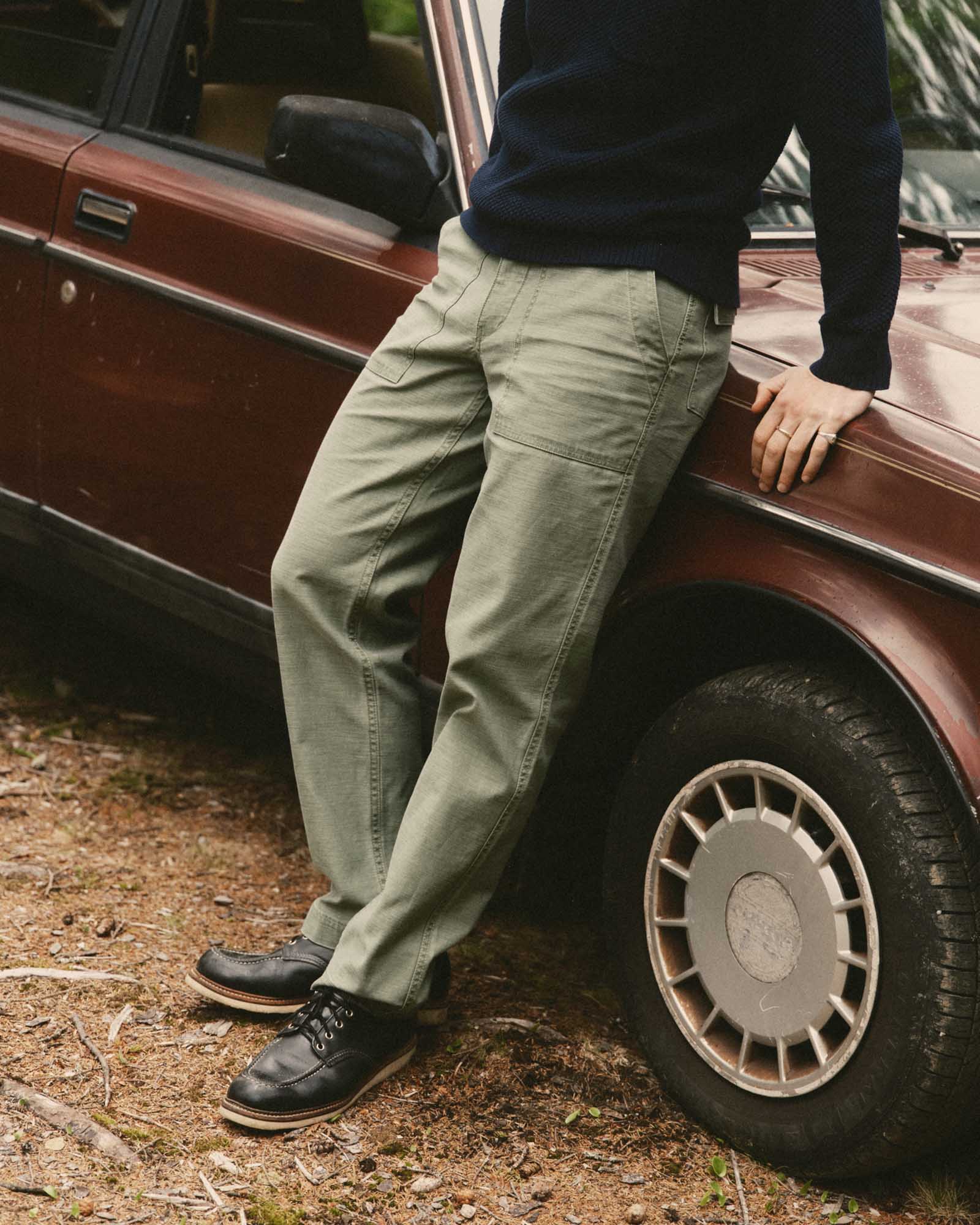 fit model posing in The Surplus Pant in Field Olive Reverse Sateen, Bottoms by Taylor Stitch