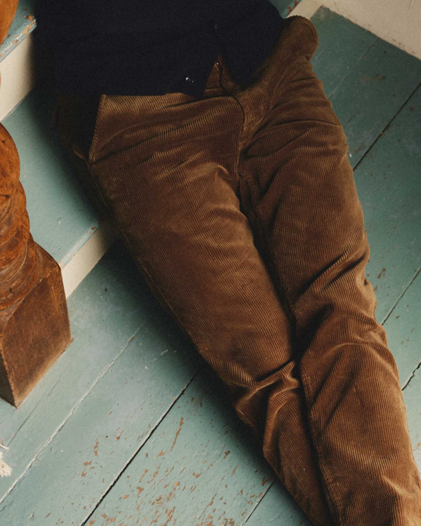fit model sitting wearing The Carnegie Pant in Bourbon Corduroy, Bottoms by Taylor Stitch