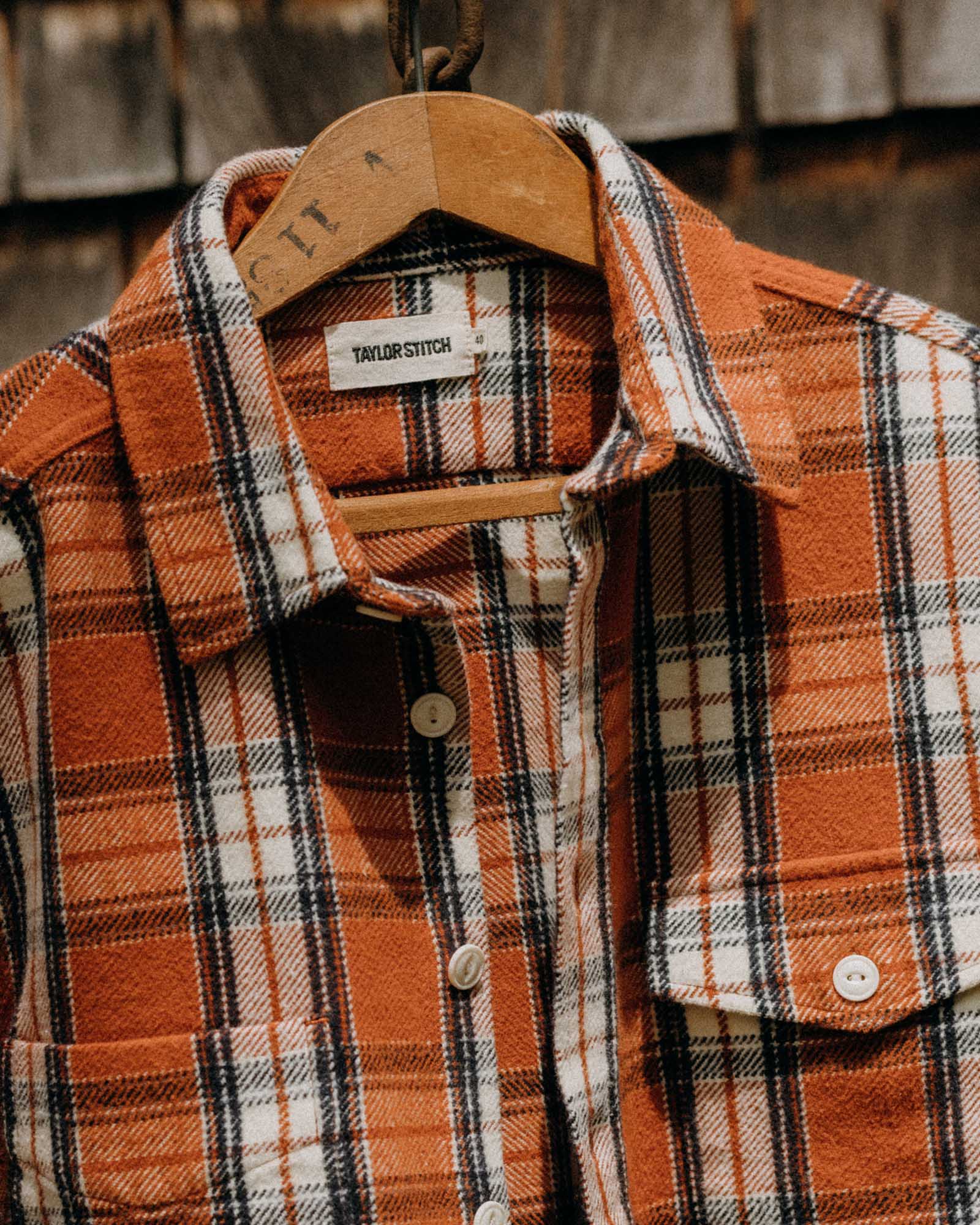 editorial image of The Crater Shirt in Brick Plaid on a hanger, Wovens by Taylor Stitch
