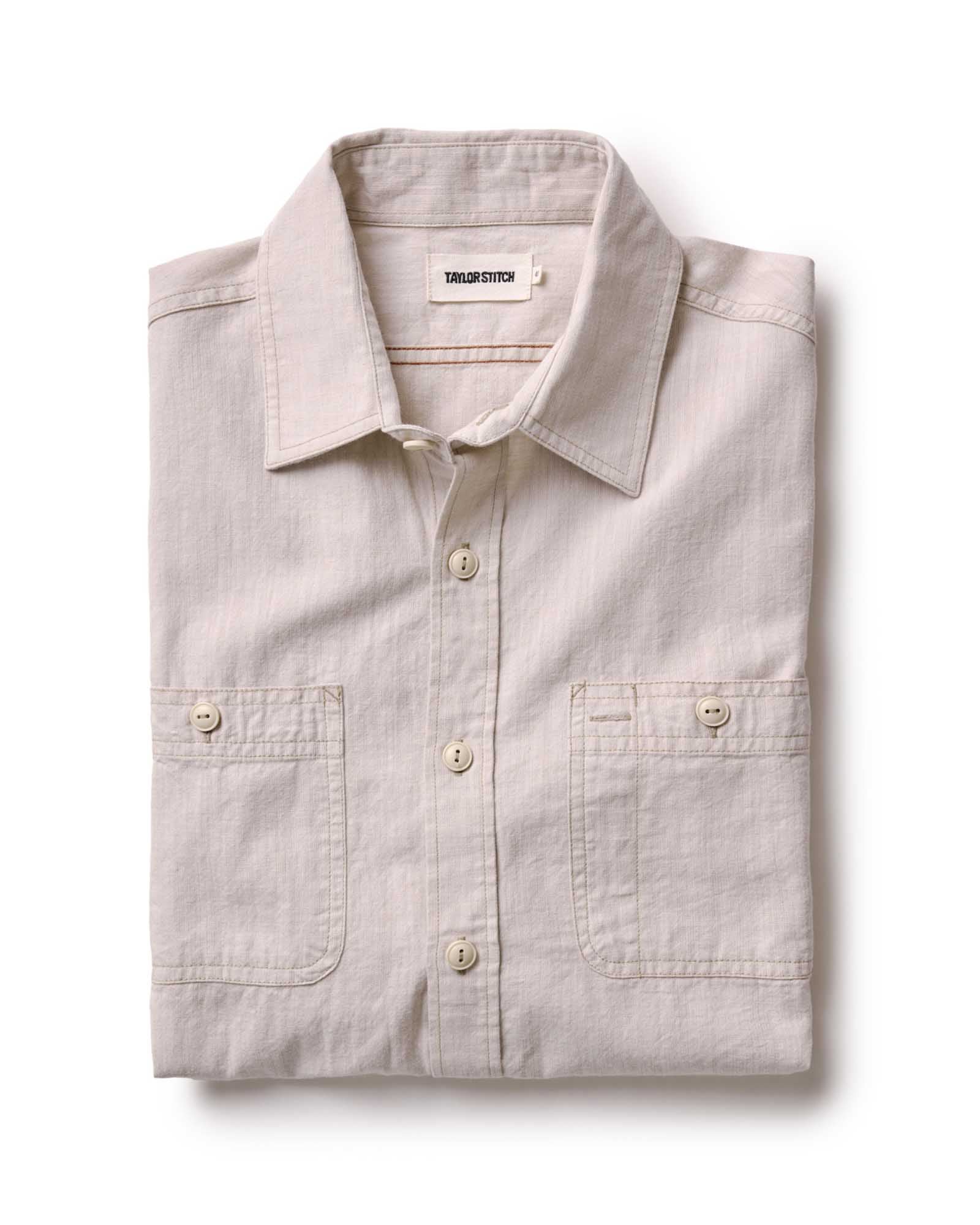 folded flatlay of The Foundry Shirt in Natural Chambray, Wovens by Taylor Stitch