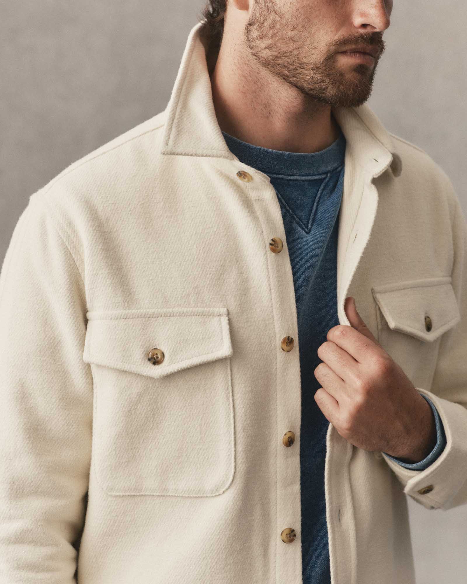 fit model holding The Maritime Shirt Jacket in Vintage White Moleskin Twill, Outerwear by Taylor Stitch