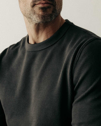 fit model showing off the sleeve on The Organic Cotton Crew in Faded Black Waffle