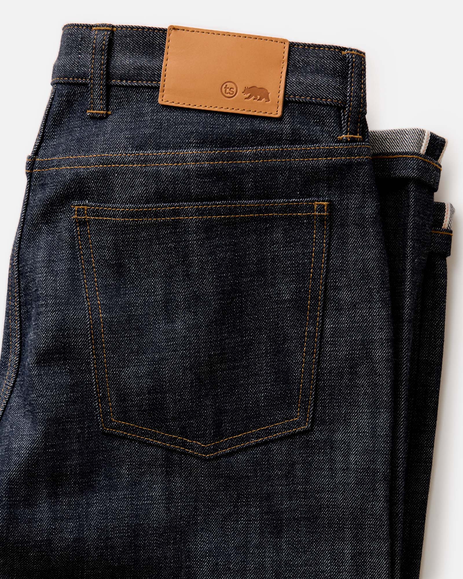 folded flatlay of the back of The Slim Jean in Rigid Organic Selvedge, Bottoms by Taylor Stitch