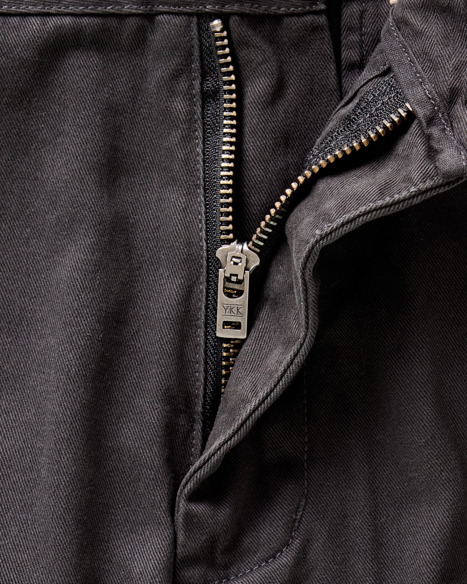 material shot of the YKK zipper fly on The Slim Foundation Pant in Organic Faded Black, Bottoms by Taylor Stitch