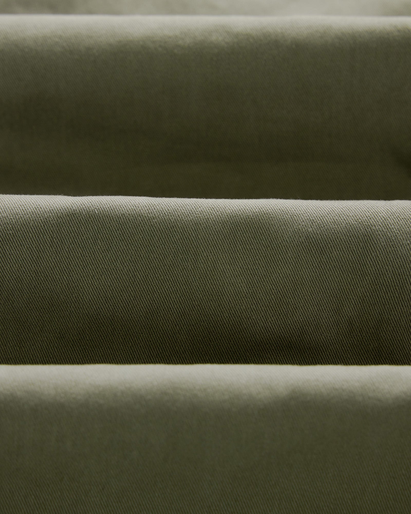 material shot of the twill fabric on The Slim Foundation Pant in Organic Smoked Olive, Bottoms by Taylor Stitch