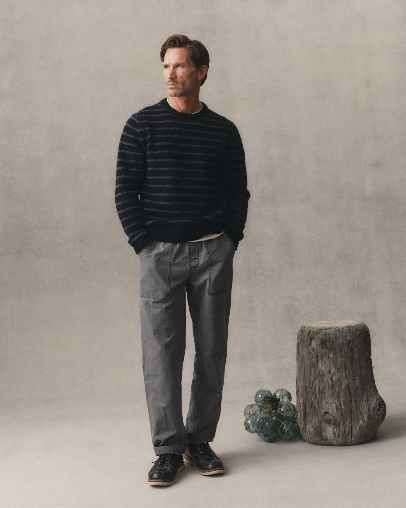 fit model with his hands in the pockets of The Breakwater Pant in Dark Grey Ripstop, Bottoms by Taylor Stitch