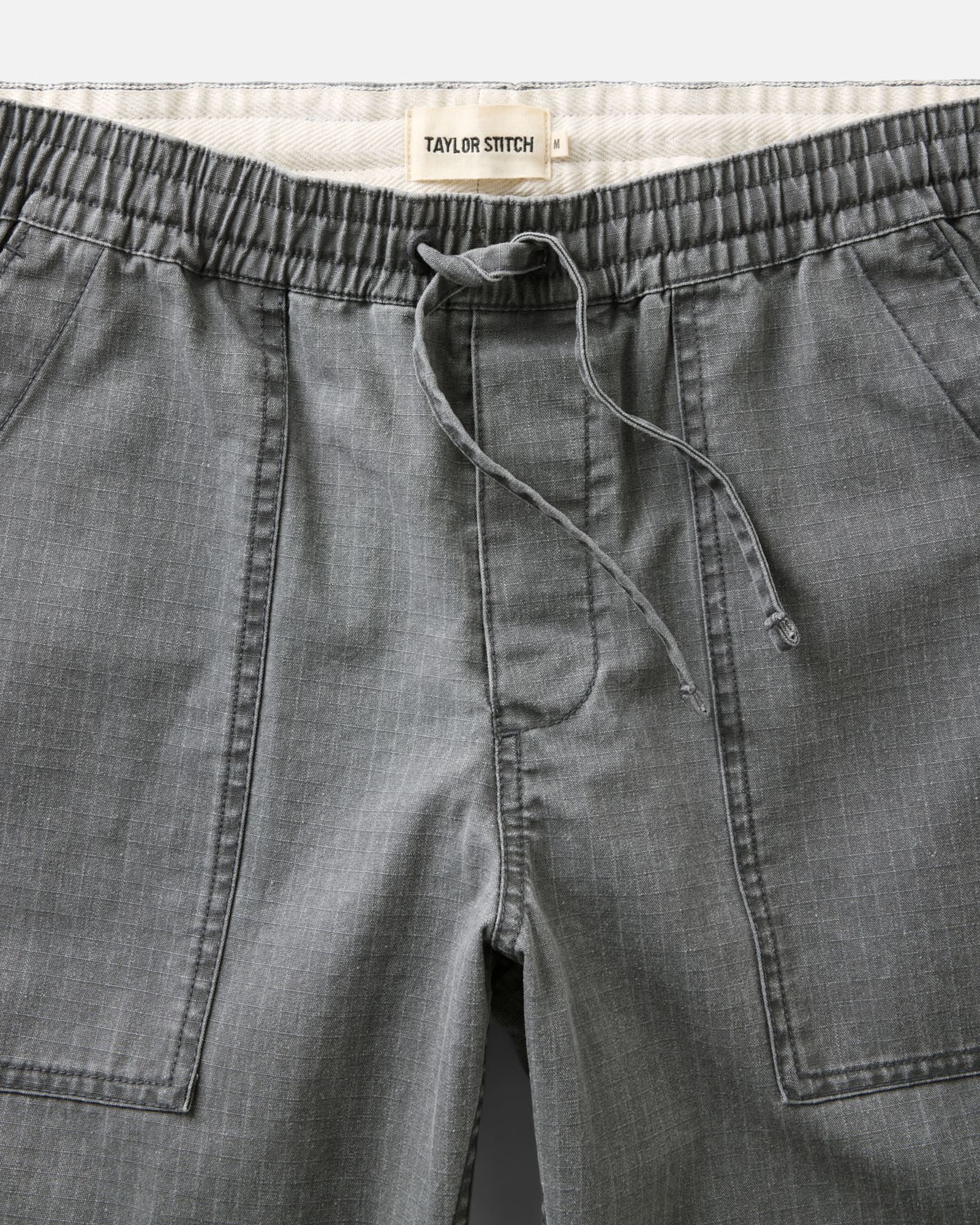 material shot of the waistband on The Breakwater Pant in Dark Grey Ripstop, Bottoms by Taylor Stitch